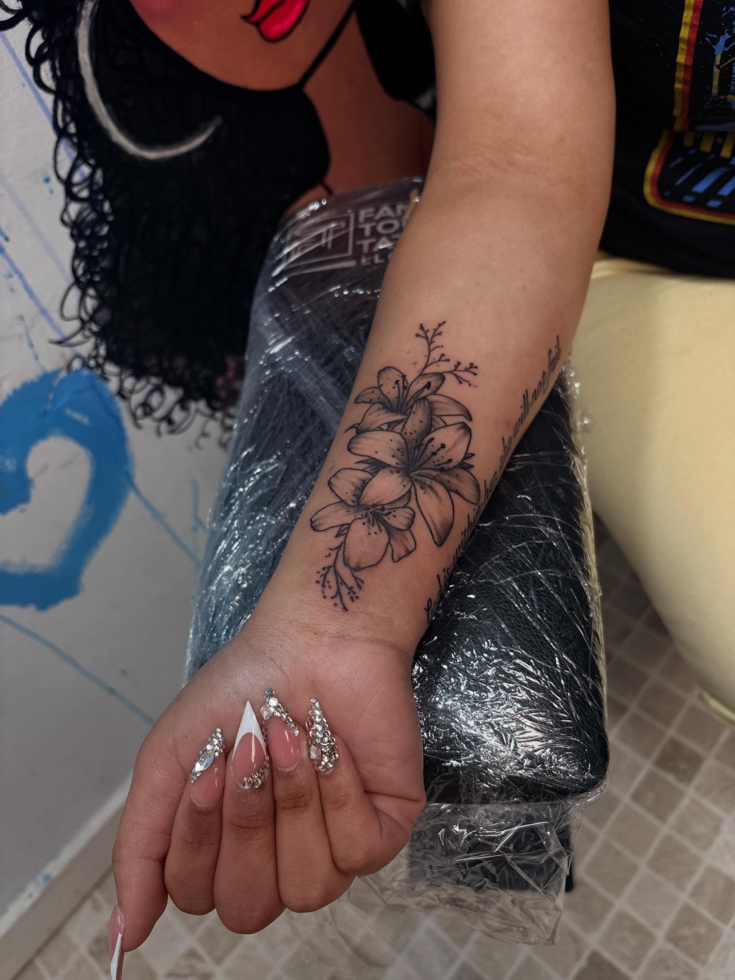 Flowers black and grey tattoo on the forearm by 𝓚𝓪𝓻𝓶𝓪💫