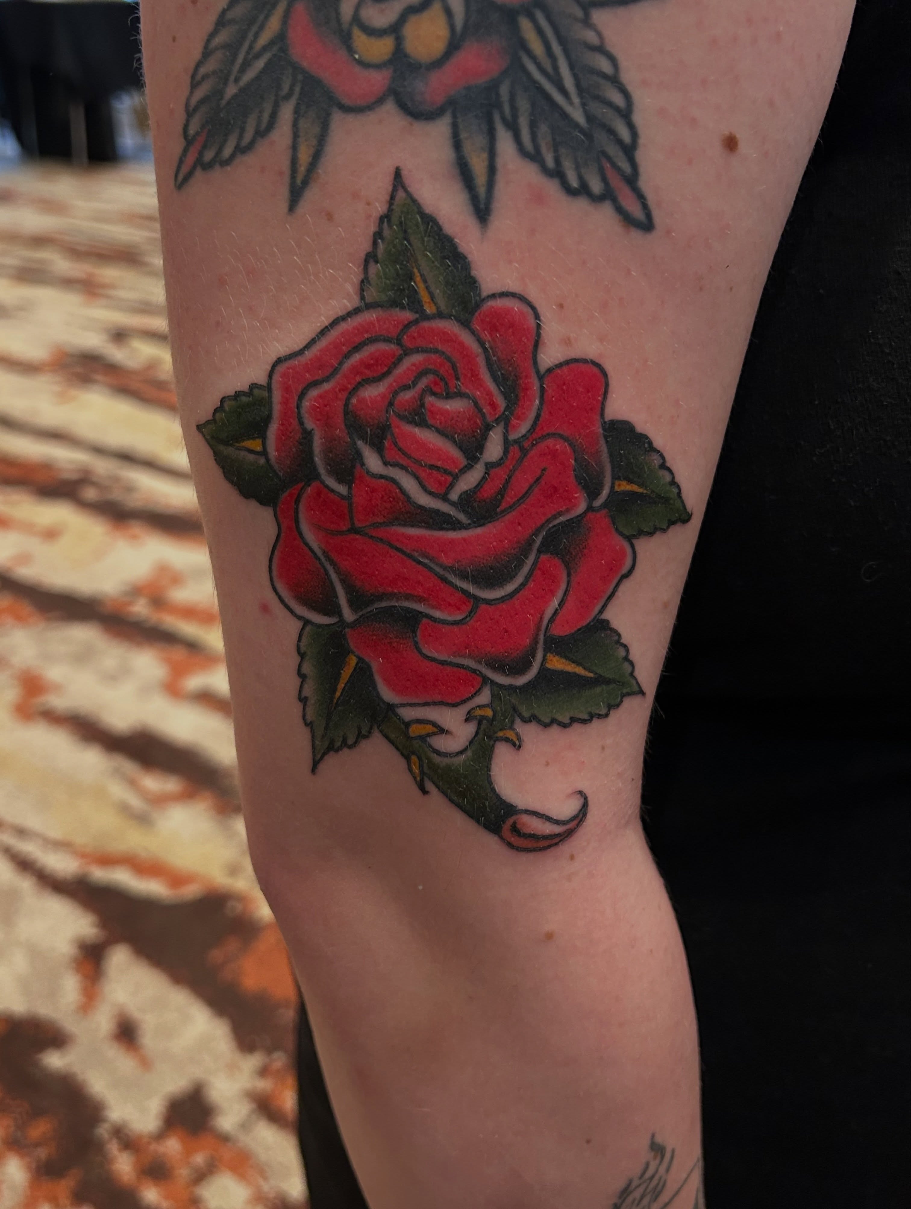 Red rose American traditional tattoo on the forearm by Erik Sacony
