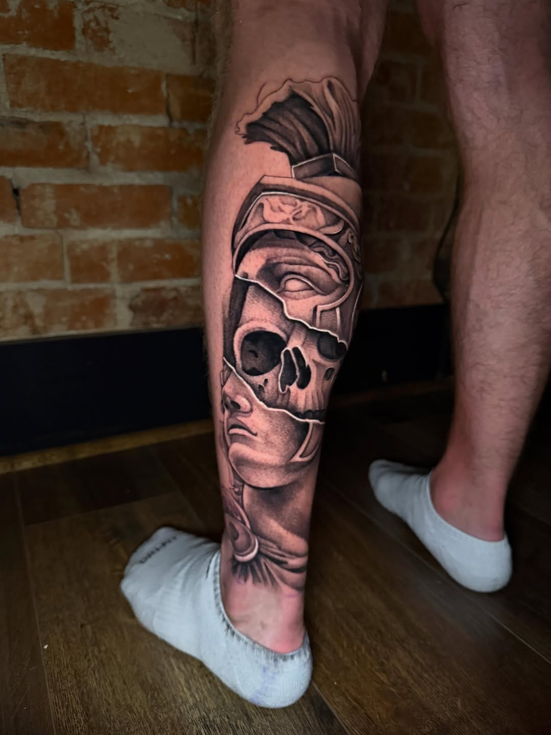 Roman helmet and skull realism tattoo on the calf by Taylor Steckman