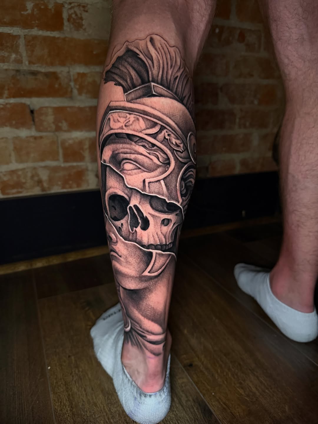 Skull in roman helmet with face realism tattoo on the calf by Taylor Steckman