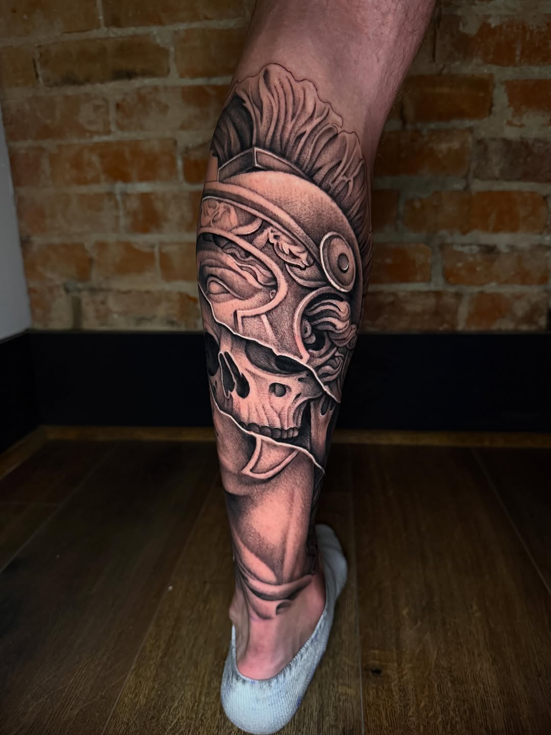 Roman helmet and skull realism tattoo on the calf by Taylor Steckman