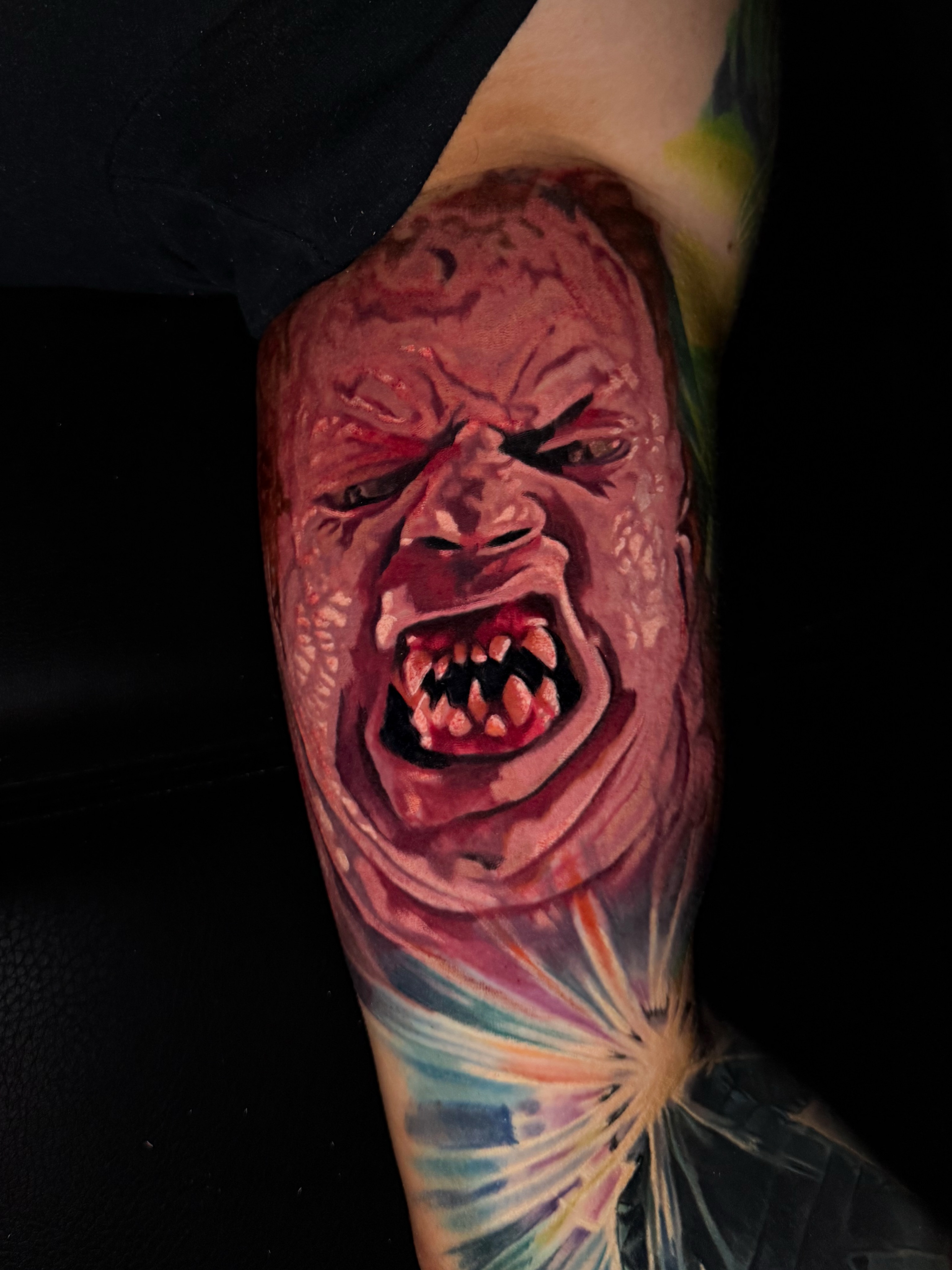 Angry face realism tattoo on the forearm by Dave James