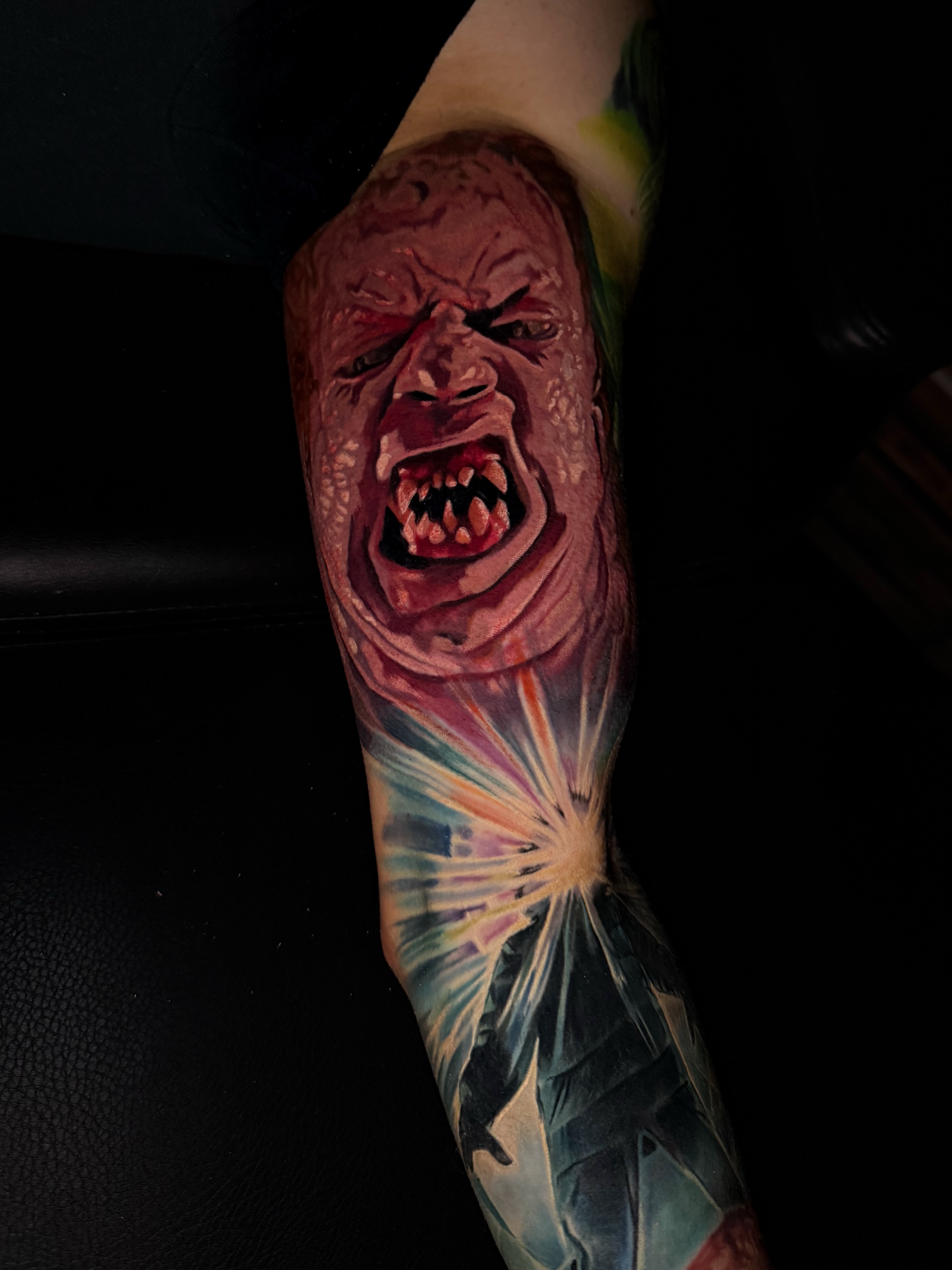 Angry face realism tattoo on the forearm by Dave James