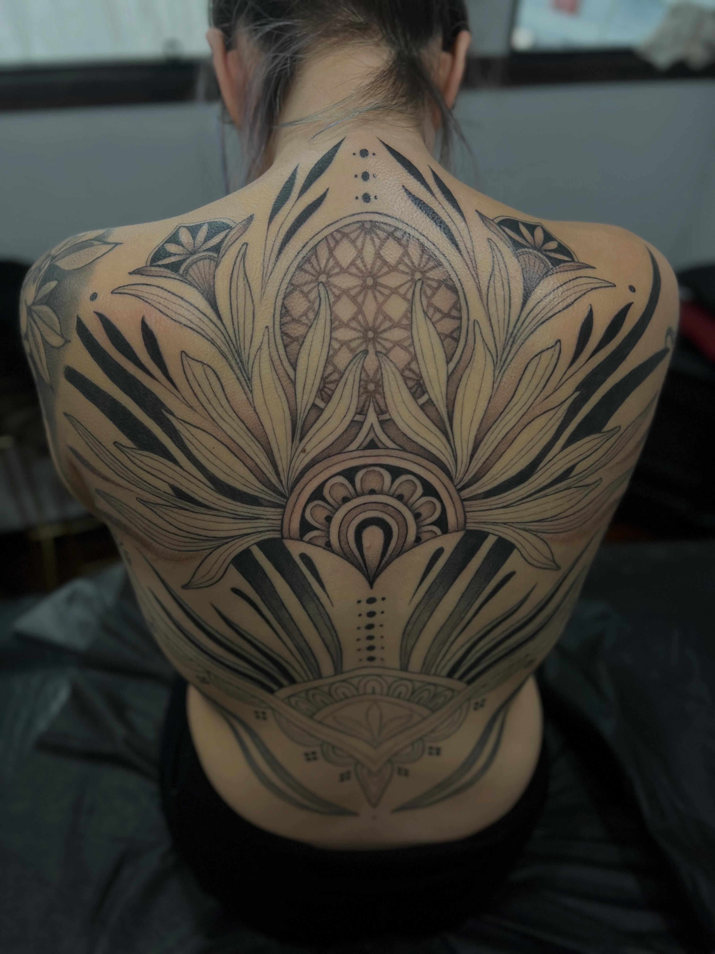 Floral mandala dotwork tattoo on the back by Avrey Simone