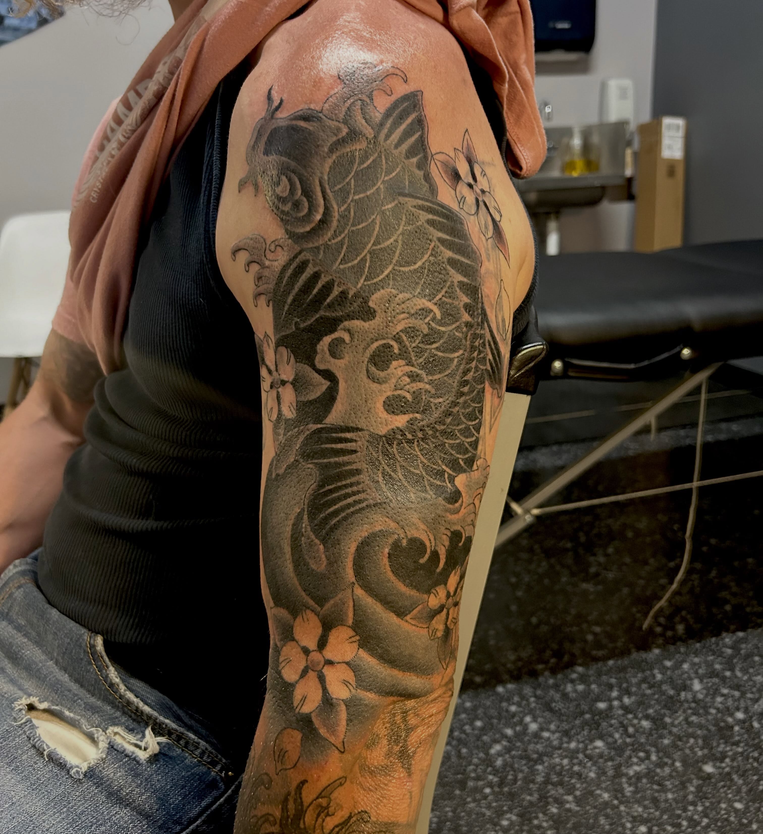 Koi fish and flowers japanese irezumi tattoo on the forearm by Jamie Winn