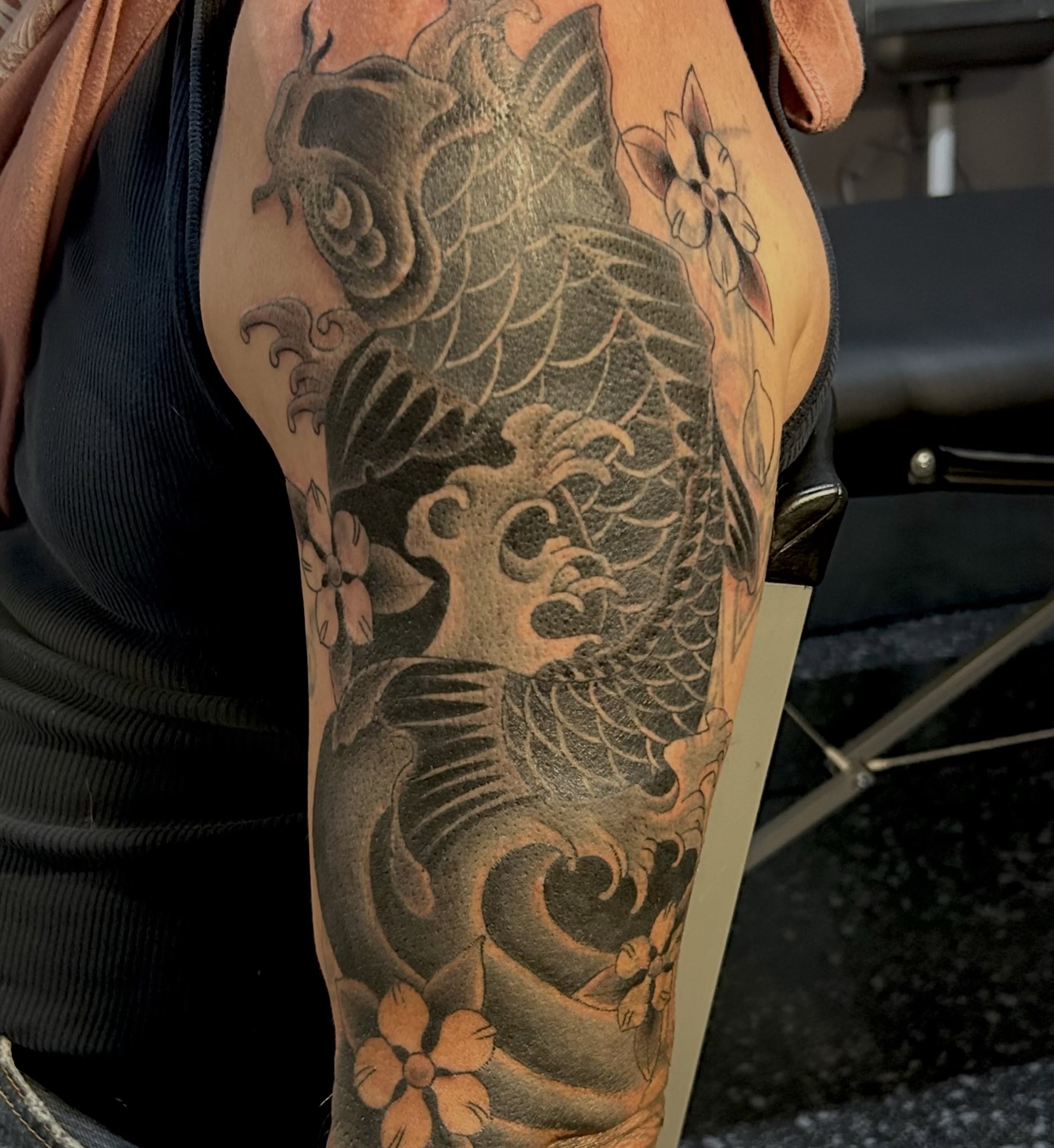 Koi fish and flowers japanese irezumi tattoo on the forearm by Jamie Winn