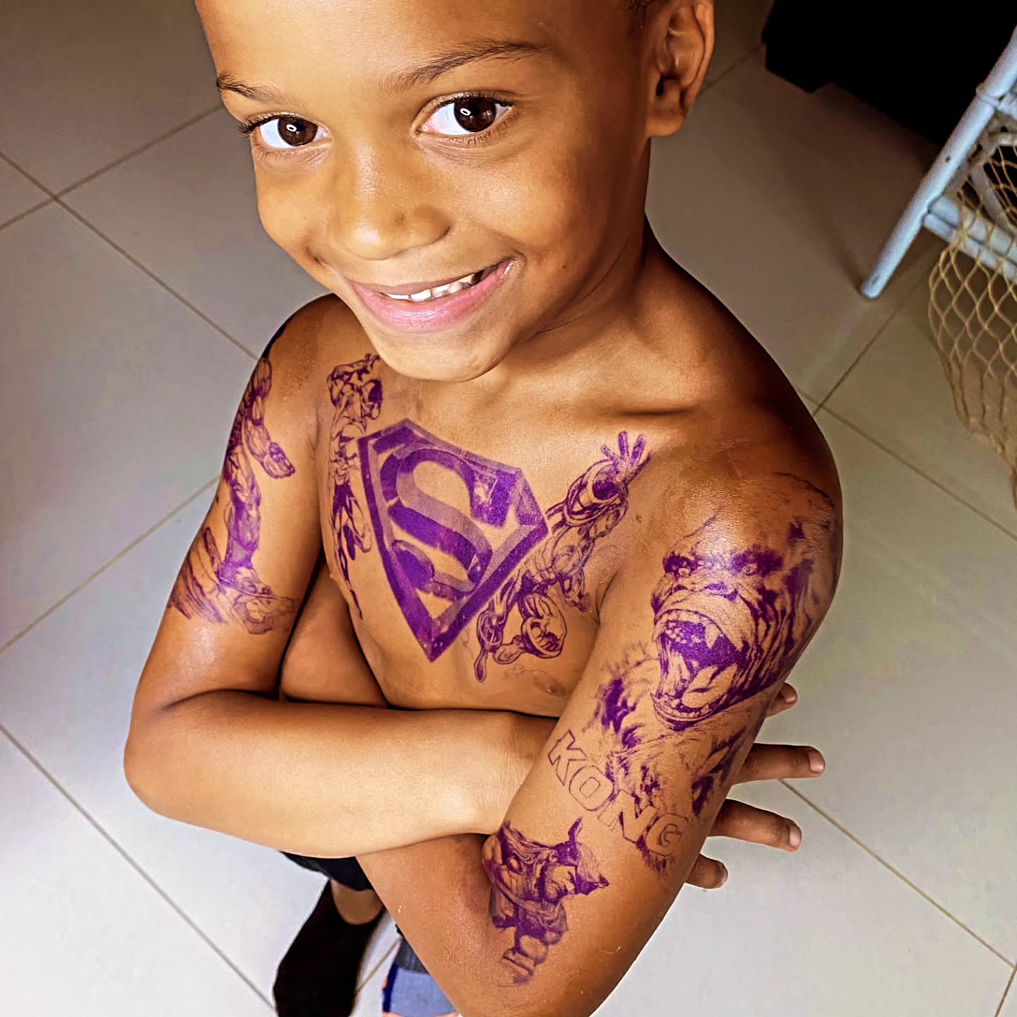 Superman logo American traditional tattoo on the chest by Klazzik Mayfield, Fort Lauderdale, Florida