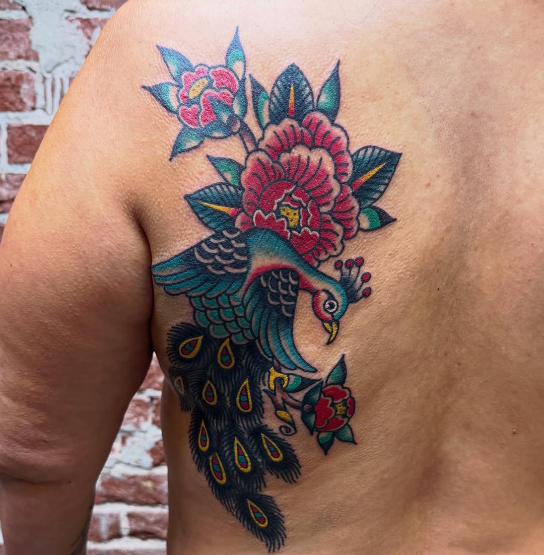 Peacock and flowers American traditional tattoo on the shoulder by Tanya Gomez