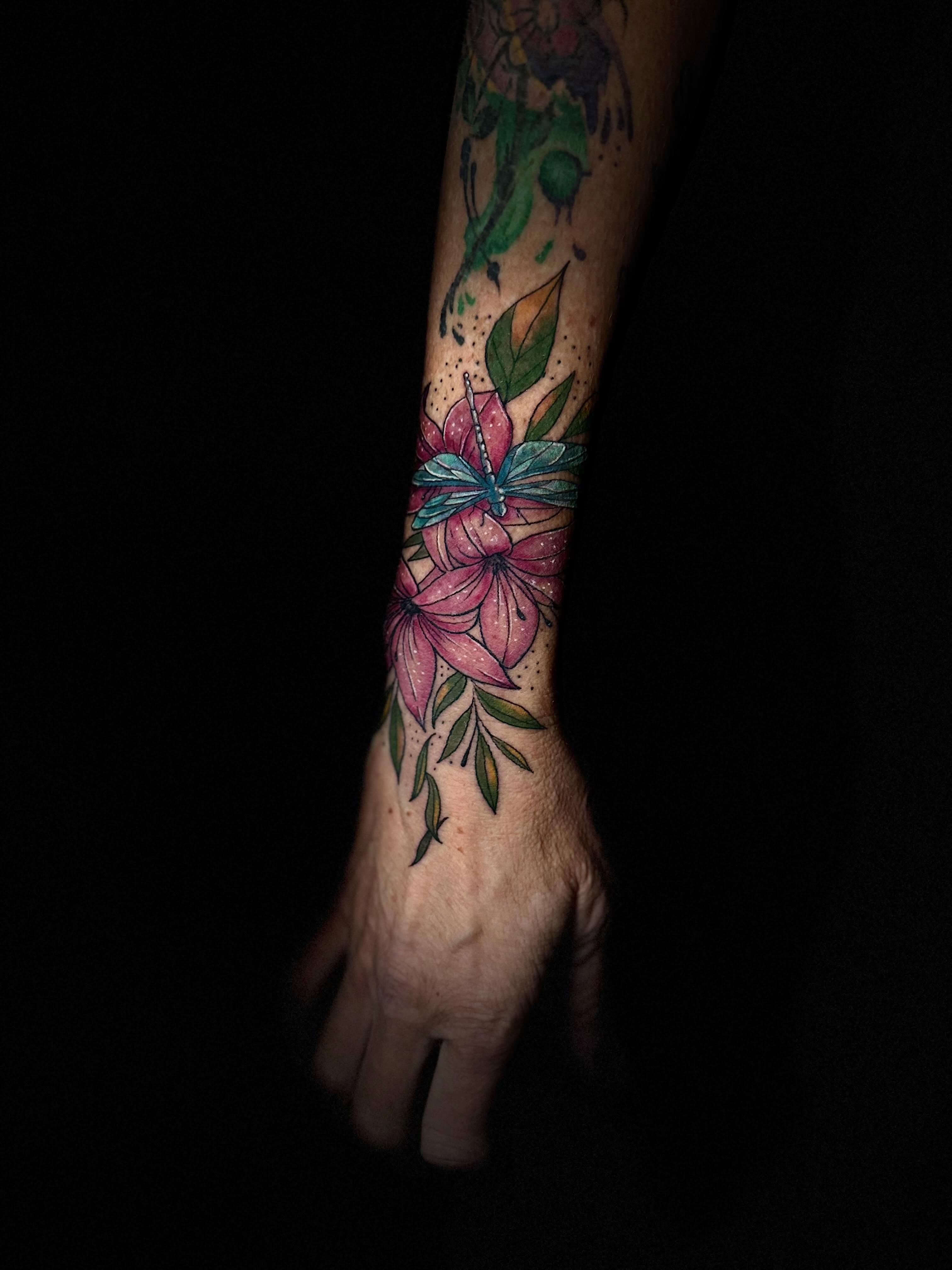 Flowers and dragonfly dotwork tattoo on the forearm by Nicholas A. Estes-Davis