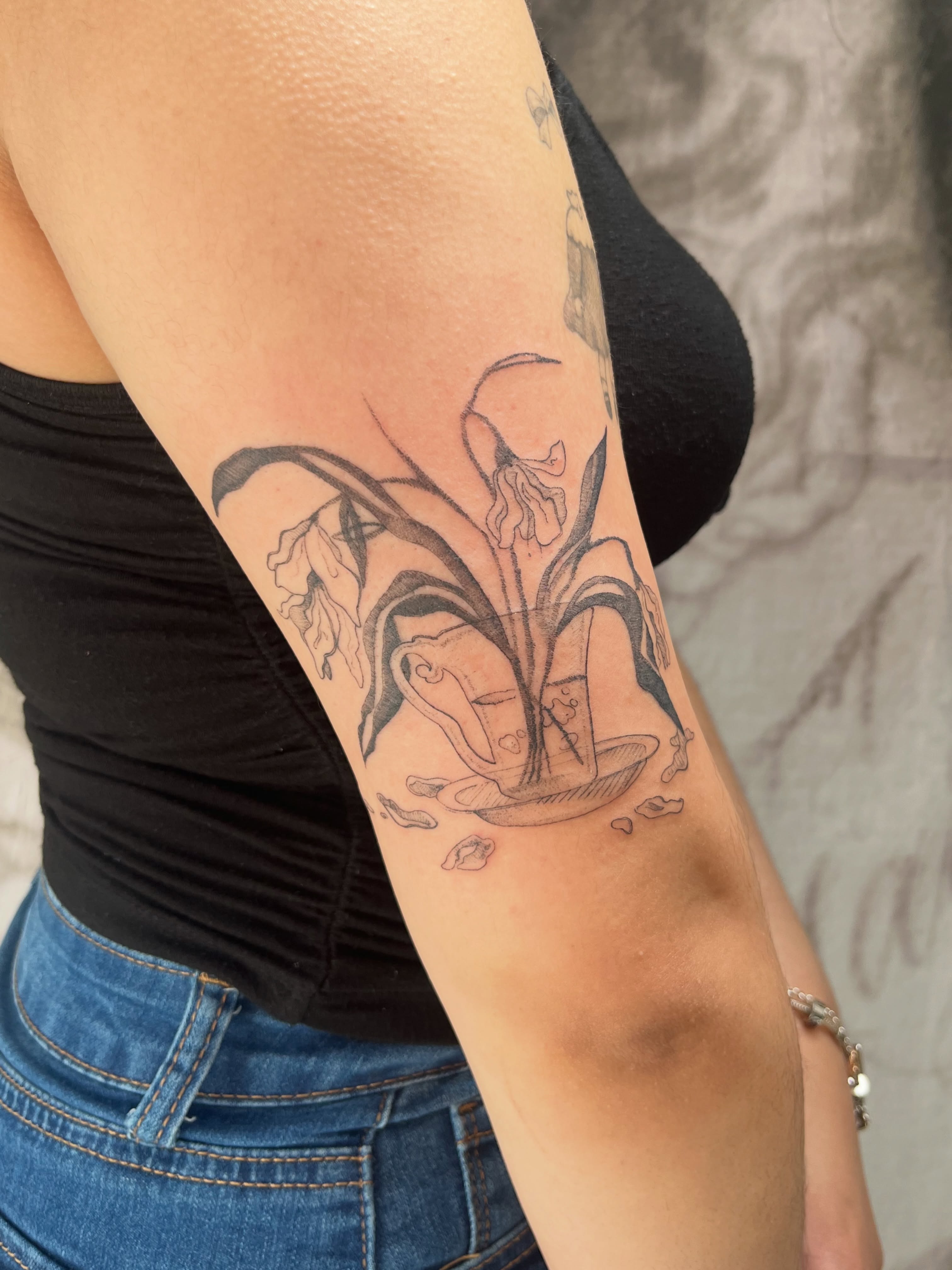 Lilies black and grey tattoo on the forearm by Kyra Monterrosa
