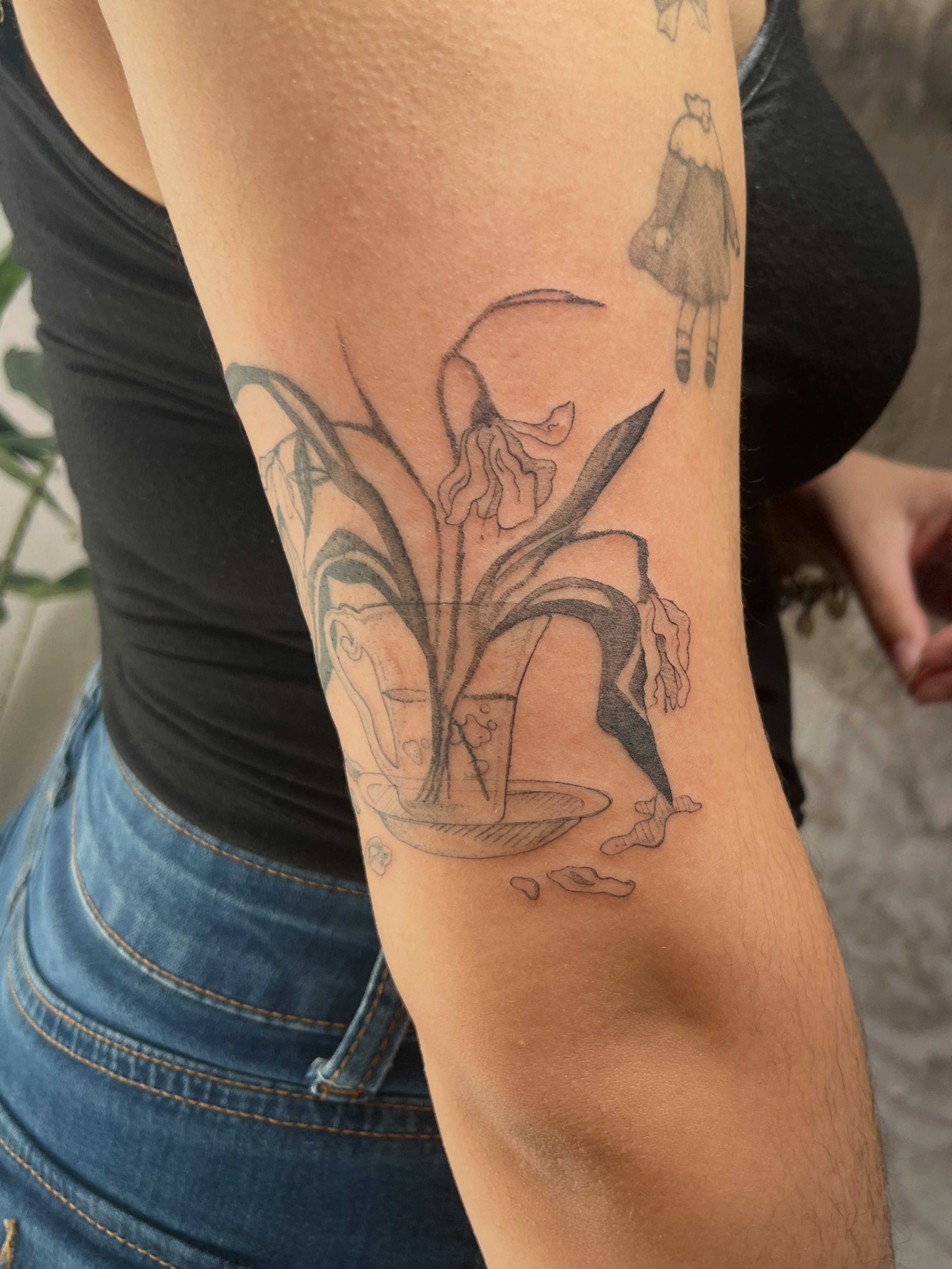 Lily black and grey tattoo on the forearm by Kyra Monterrosa