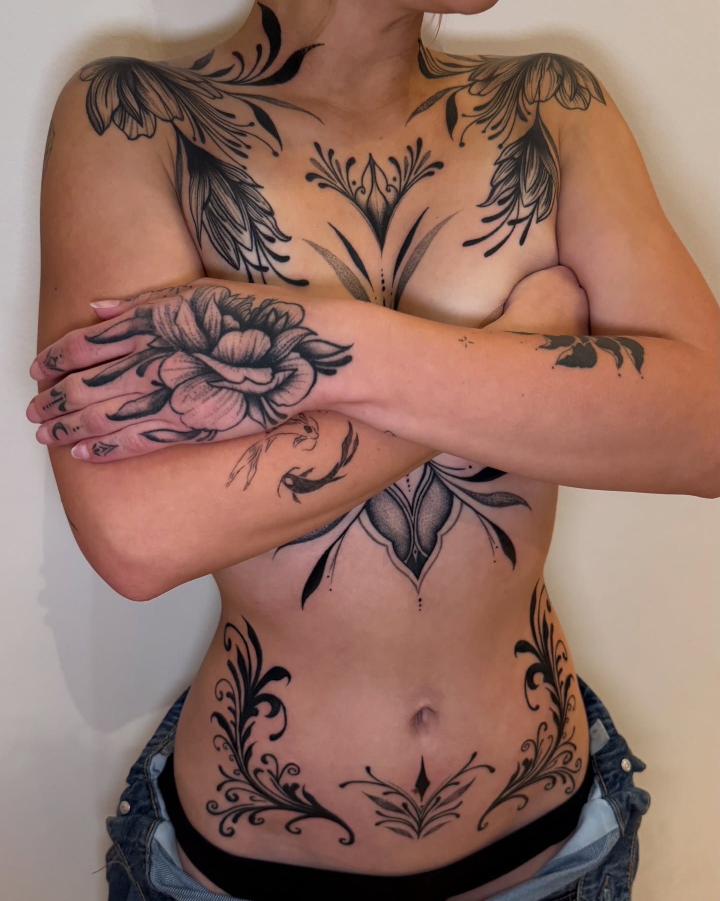 Floral ornamental tattoo on the torso by Elisa