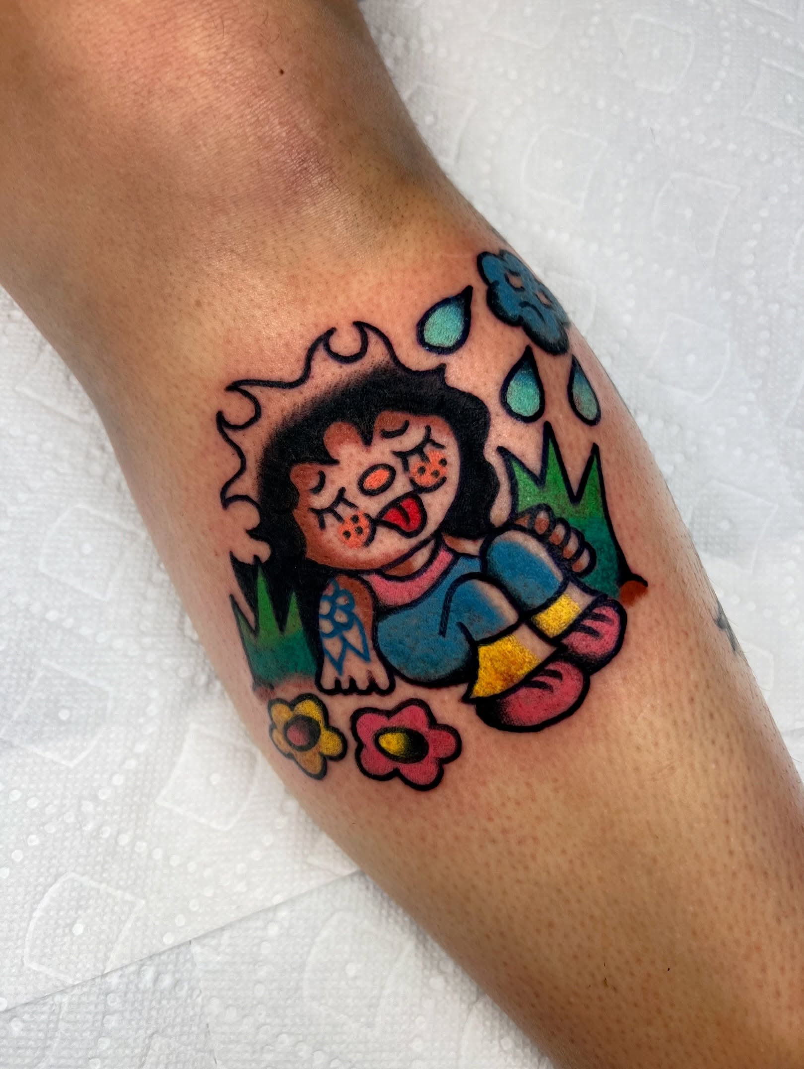 Child with flowers American traditional tattoo on the forearm by Sierra Mack