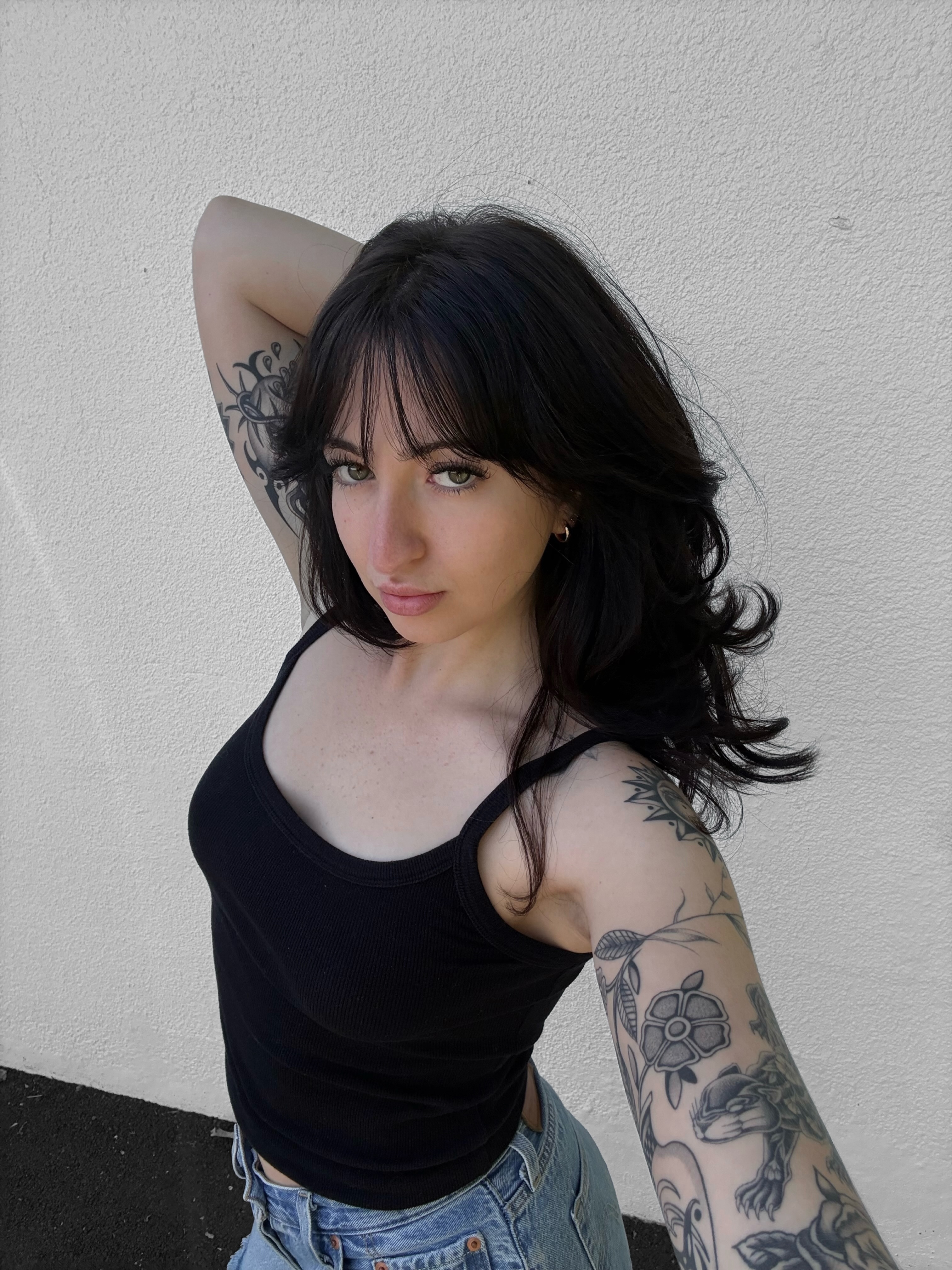 Floral black and grey tattoo on the upper arm by Ava Nilou
