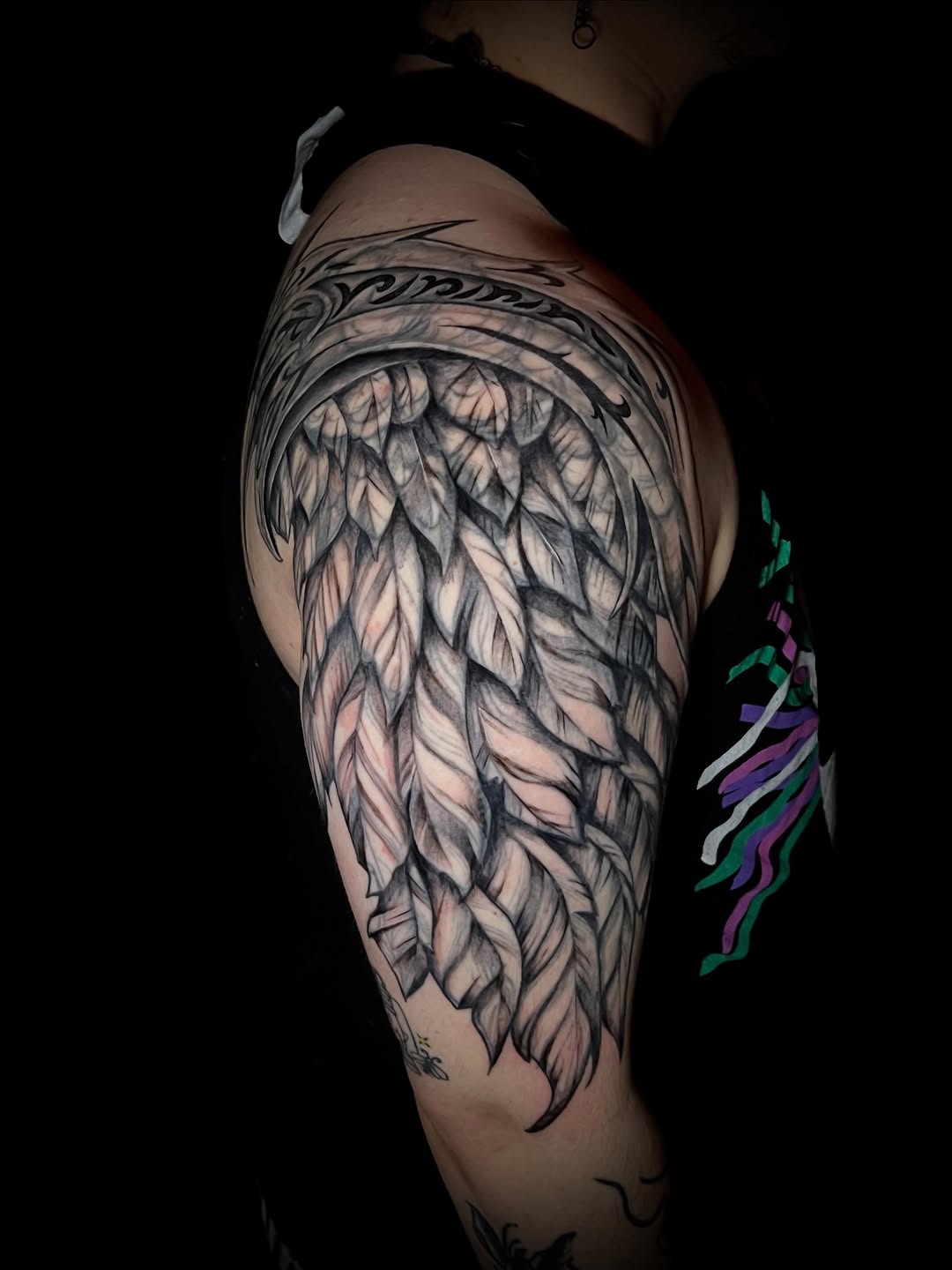 Angel wing realism tattoo on the shoulder by Saint