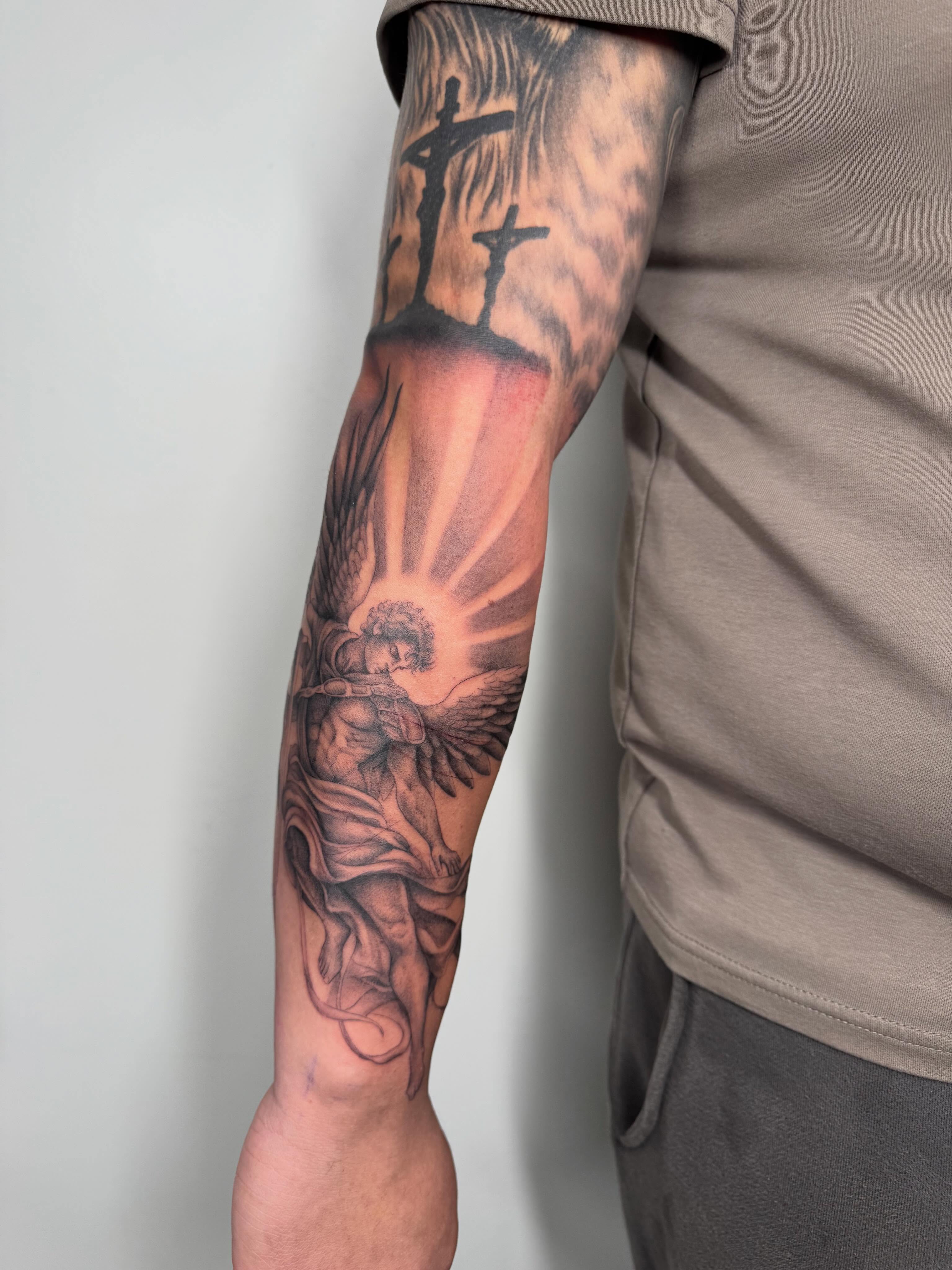 Angel with wings realism tattoo on the forearm by Danae Andino