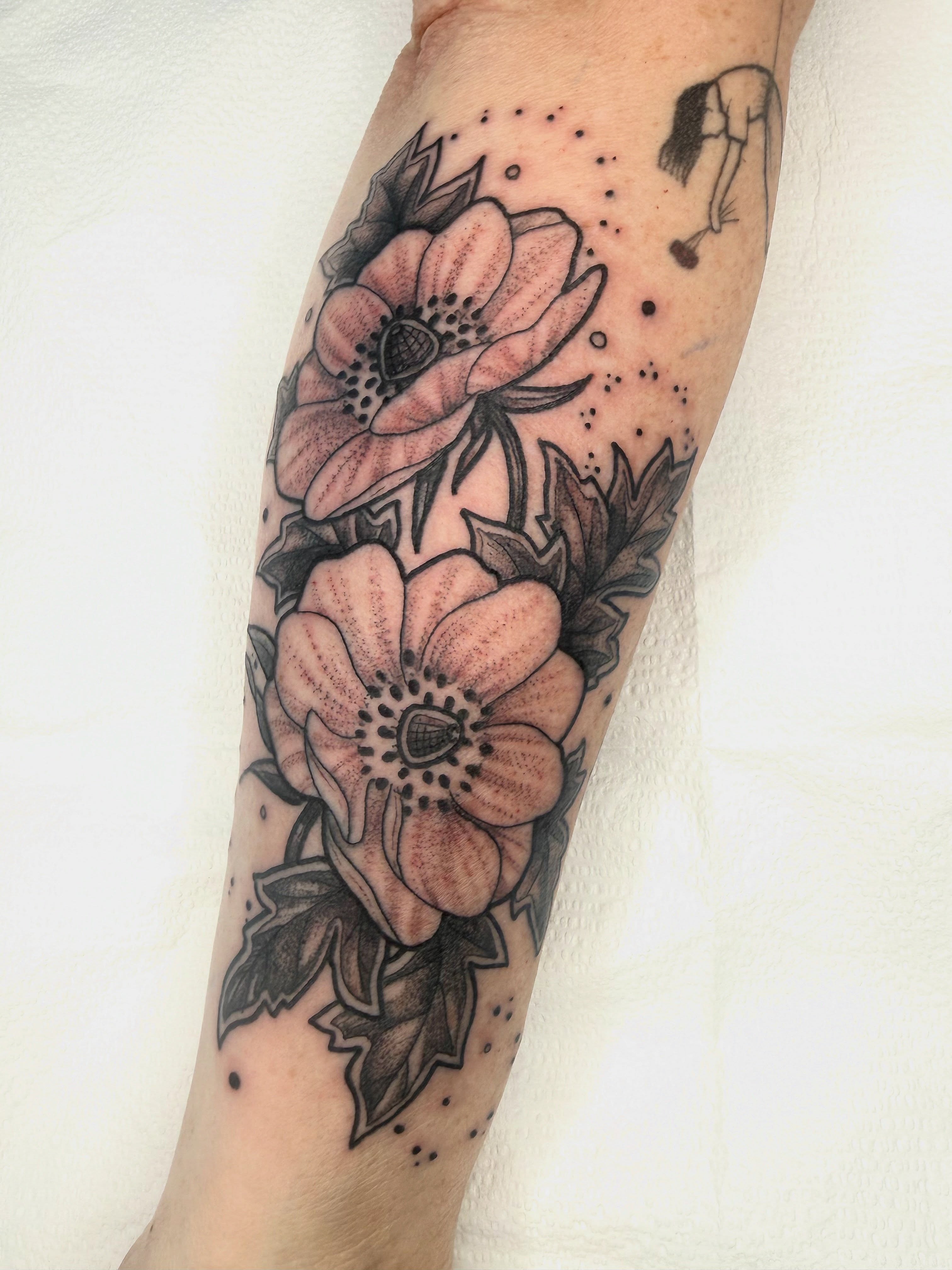 Flowers dotwork tattoo on the forearm by AJ Jensen