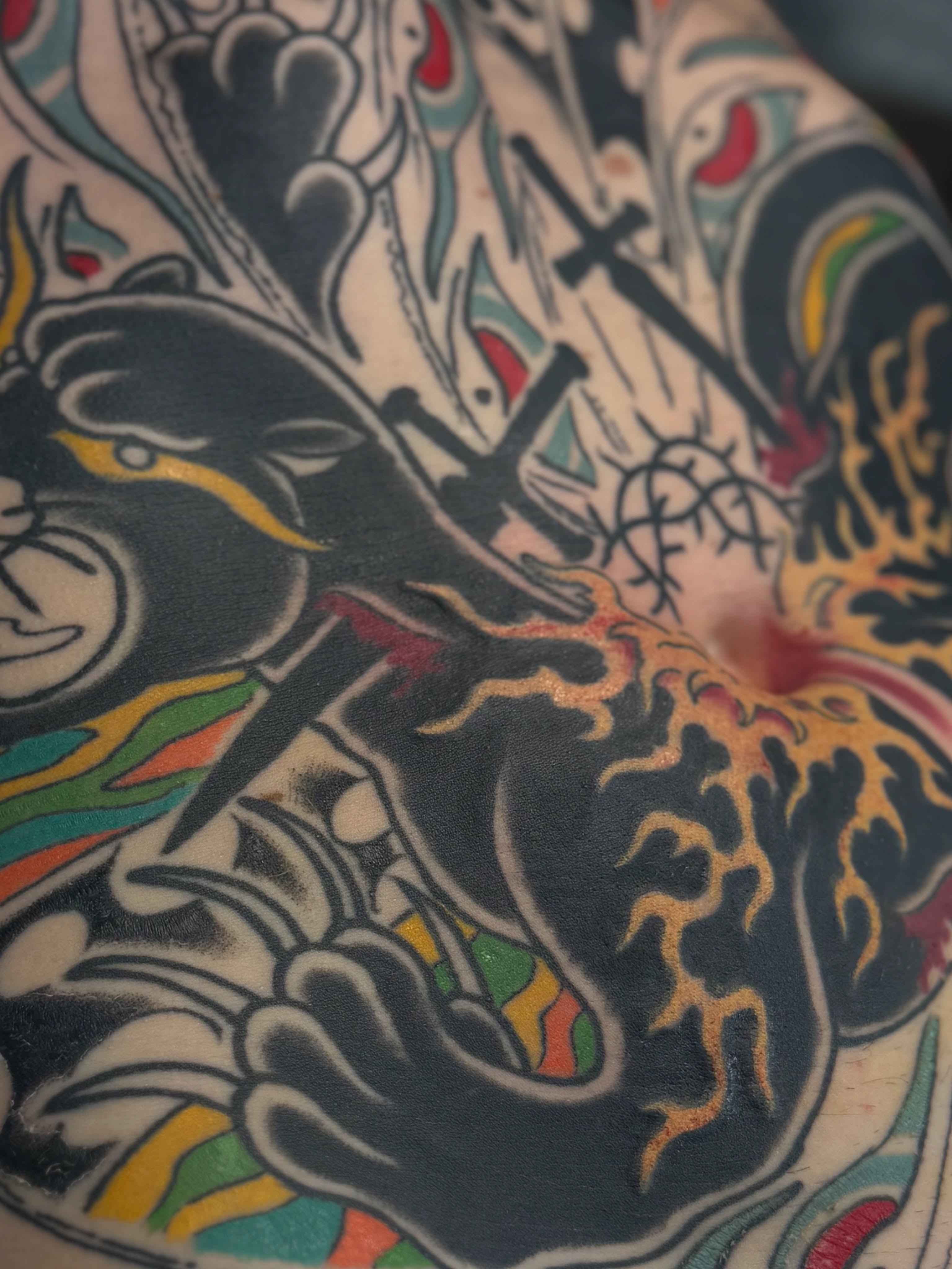 Cat and flame American traditional tattoo on the upper arm by Waylon