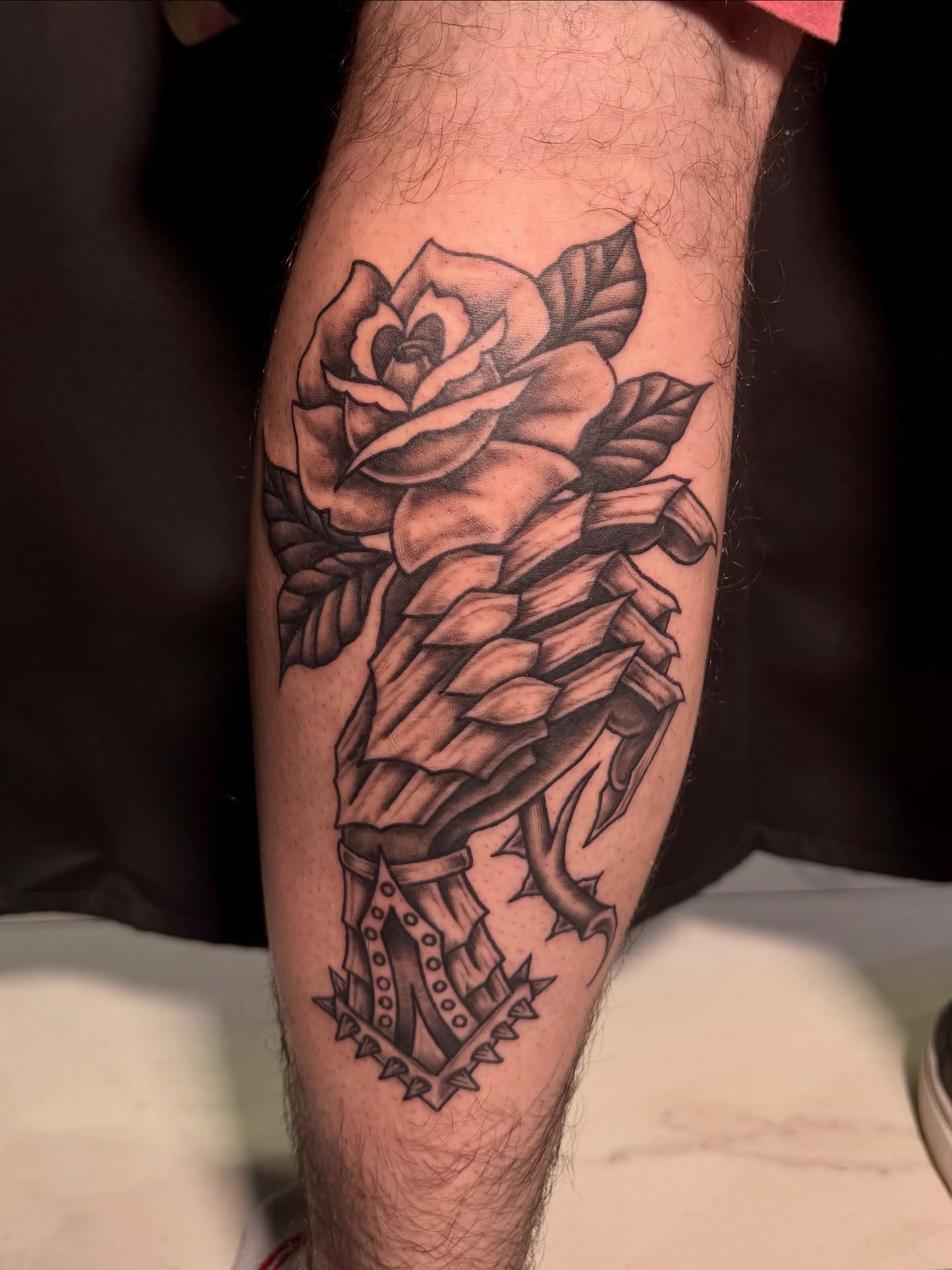Rose with thorns black and grey tattoo on the forearm by Paris Romano