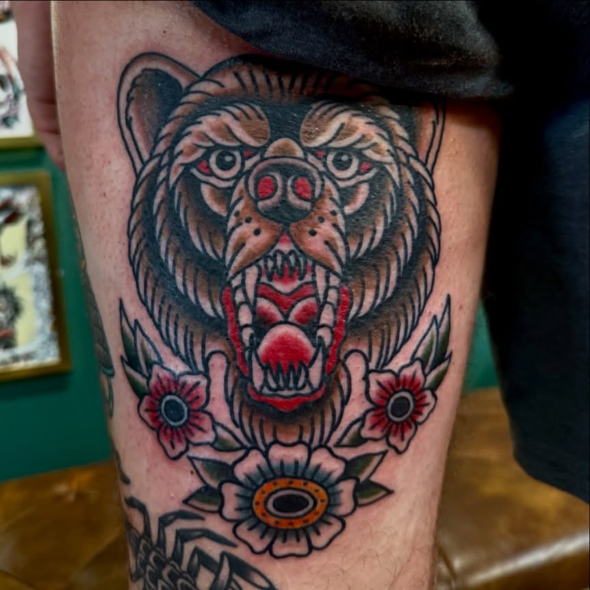 Bear and flowers American traditional tattoo on the thigh by Ryan Moraski, Colorado Springs, Colorado