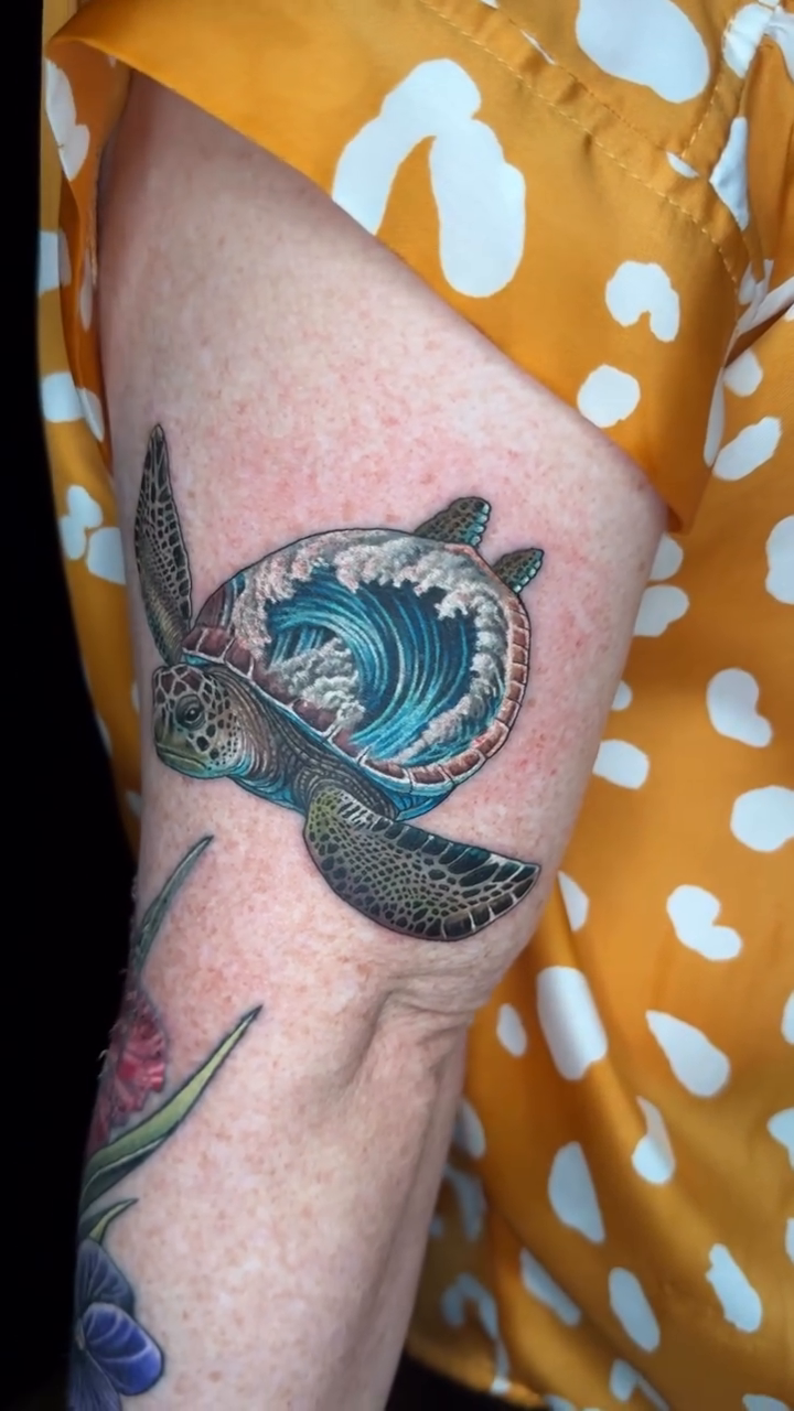 Sea turtle with a wave fine line tattoo on the forearm by Joshua Orville Vaughn, Kansas City, Missouri