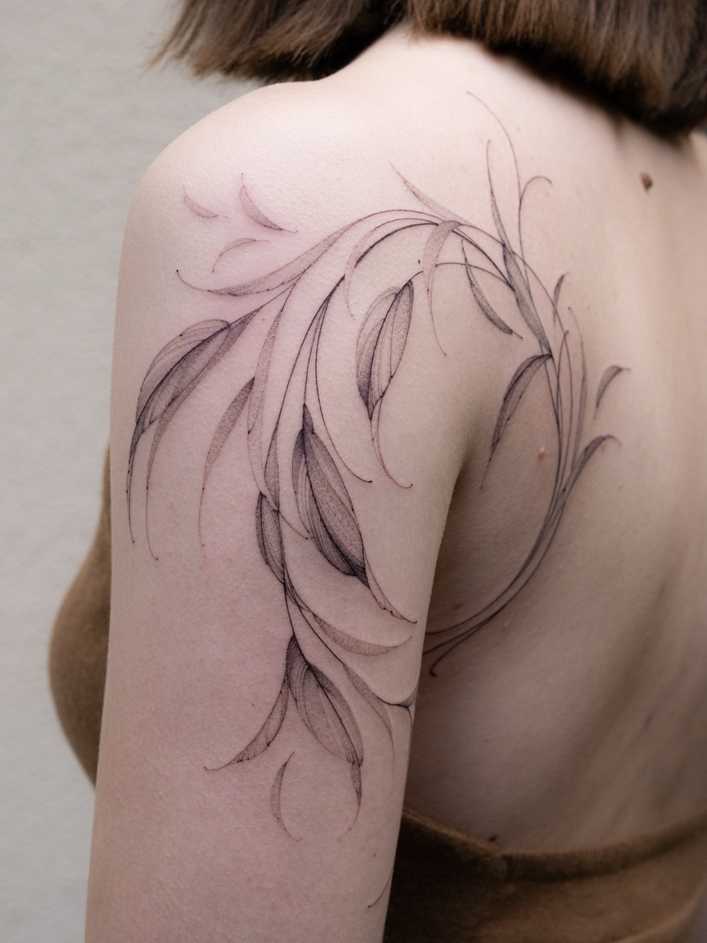 Feather black and grey tattoo on the shoulder by i flower you