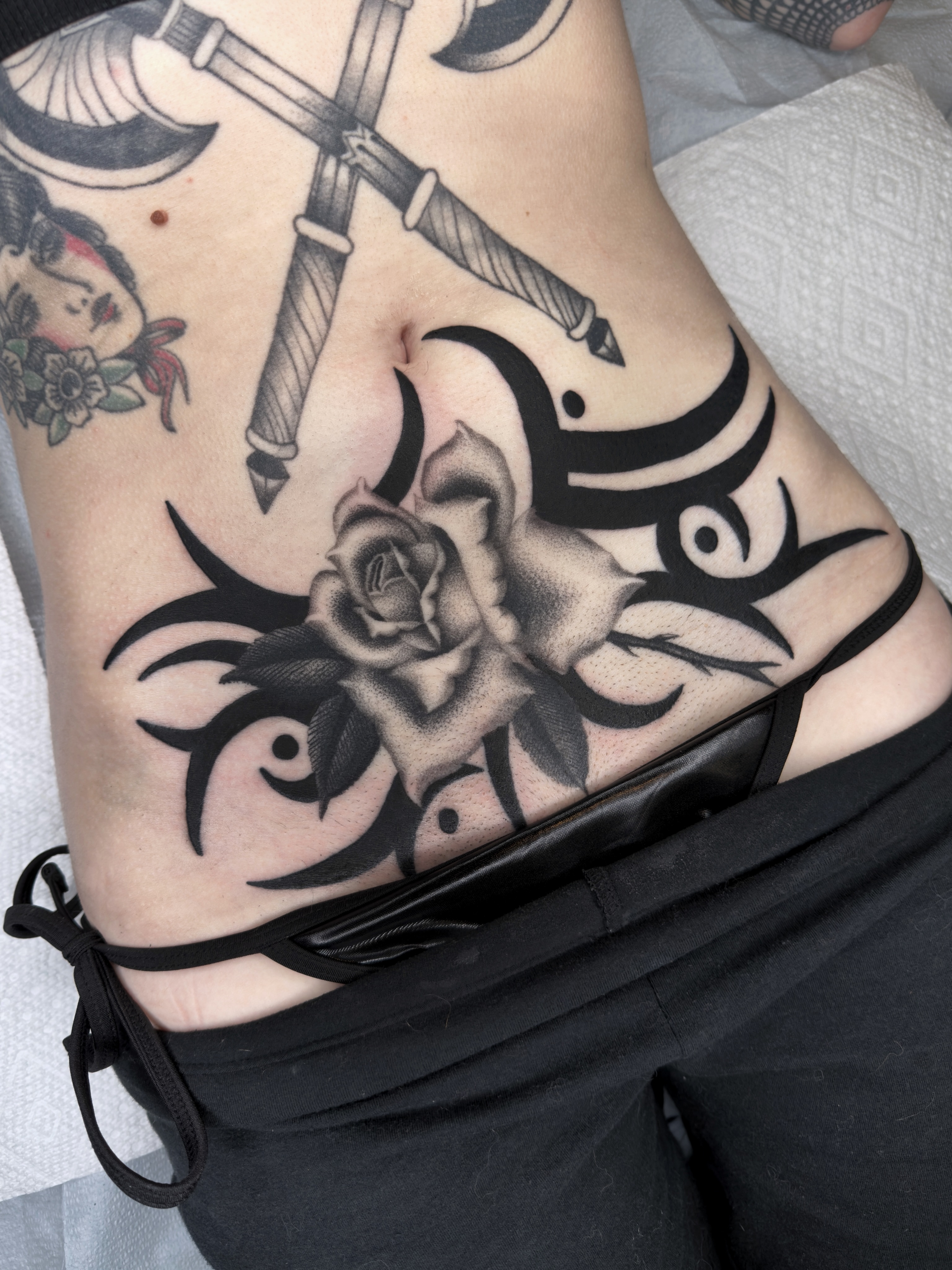 Rose and dagger tribal tattoo on the ribs by Diego Treviño