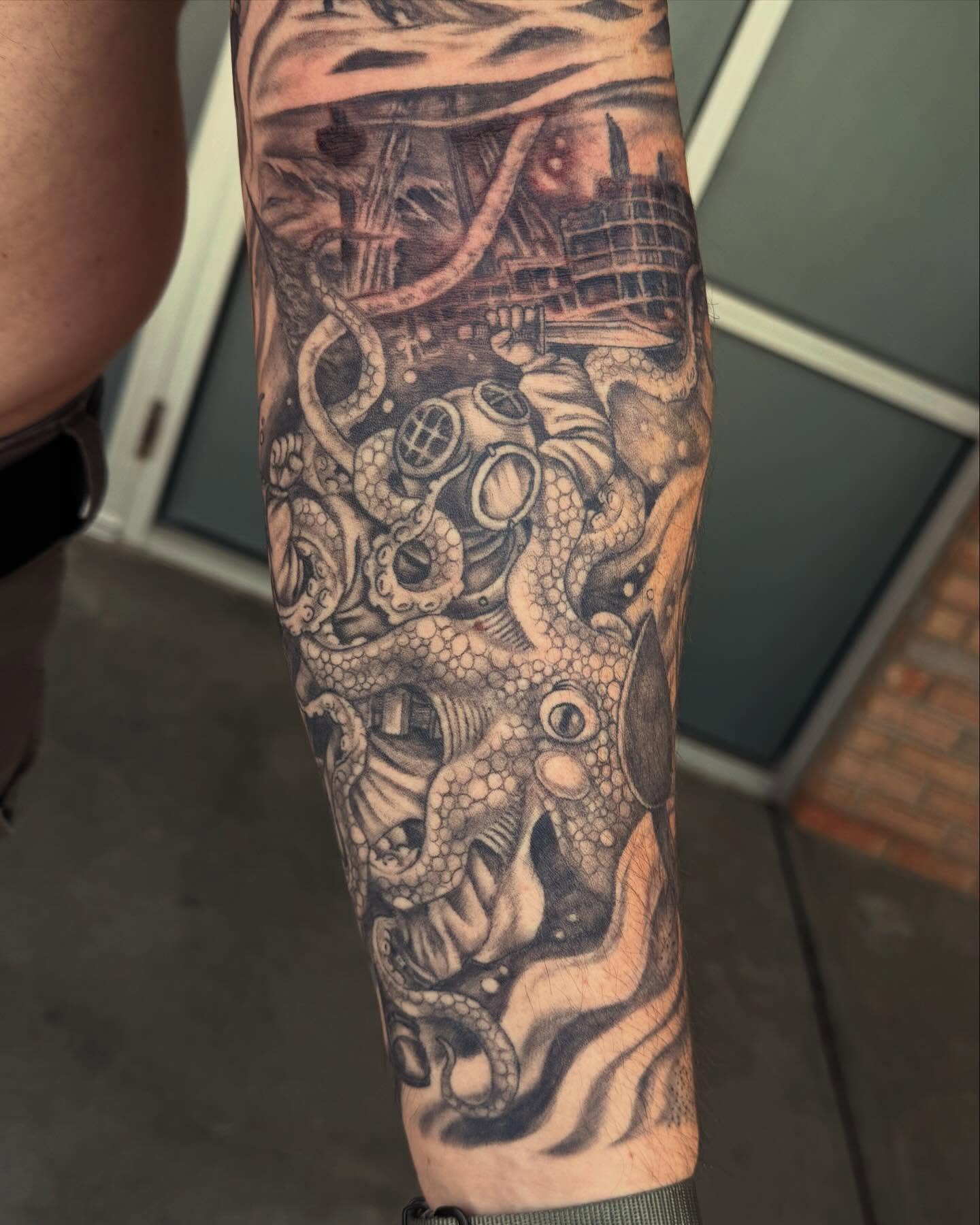 Octopus and diver realism tattoo on the forearm by Jesse Gray