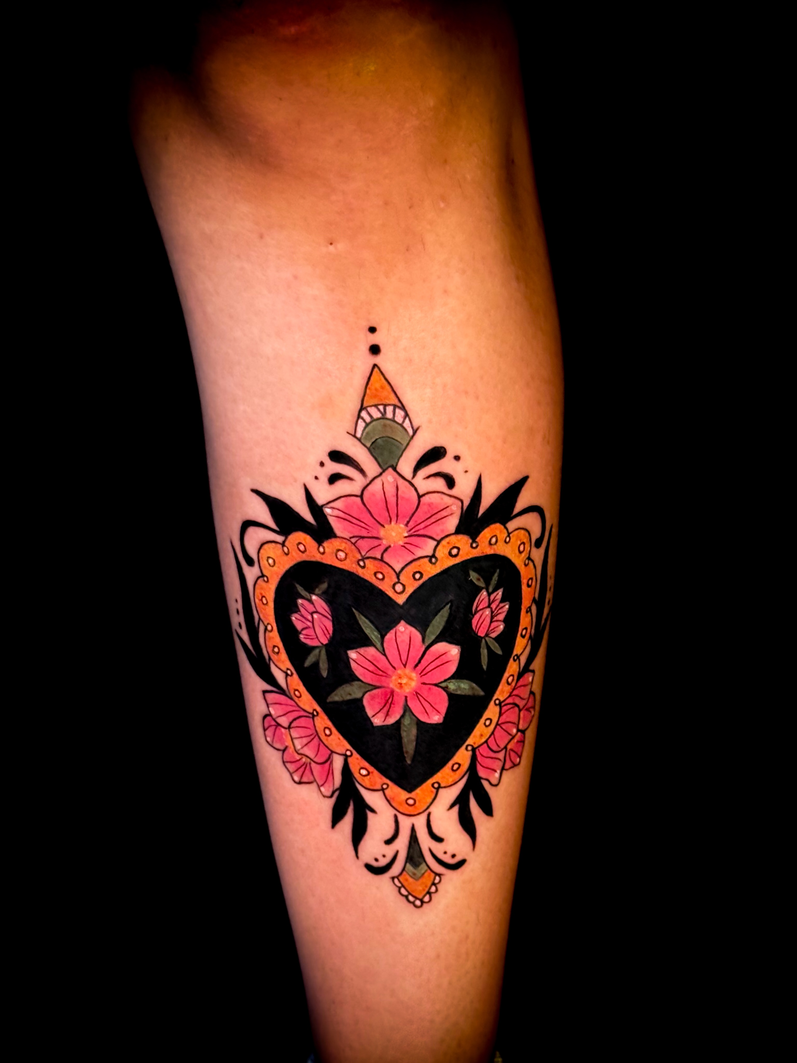 Heart with floral design American traditional tattoo on the forearm by Jennifer Ramirez