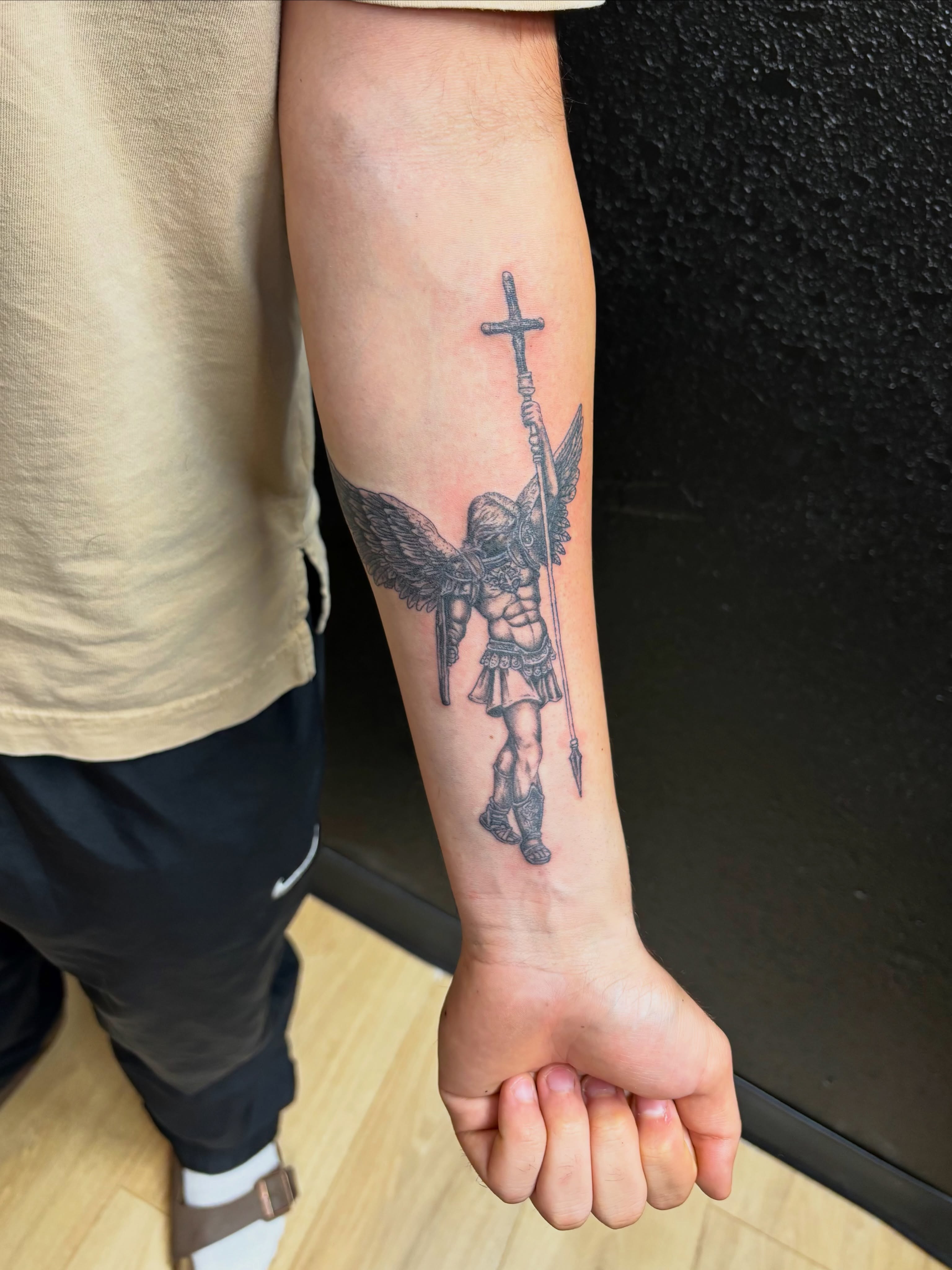 Angel with cross black and grey tattoo on the forearm by JT.tattoos