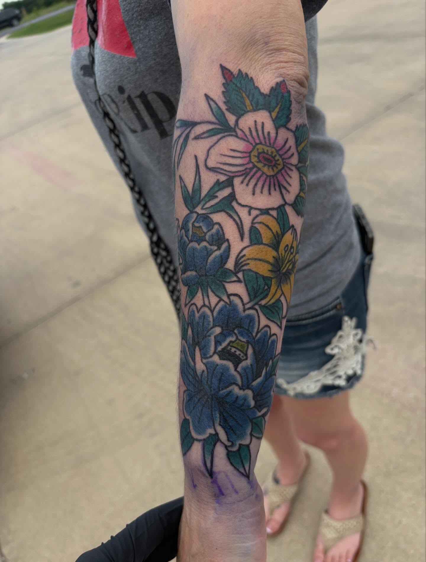 Floral bouquet American traditional tattoo on the forearm by Ethan Ellis, Dallas, Texas