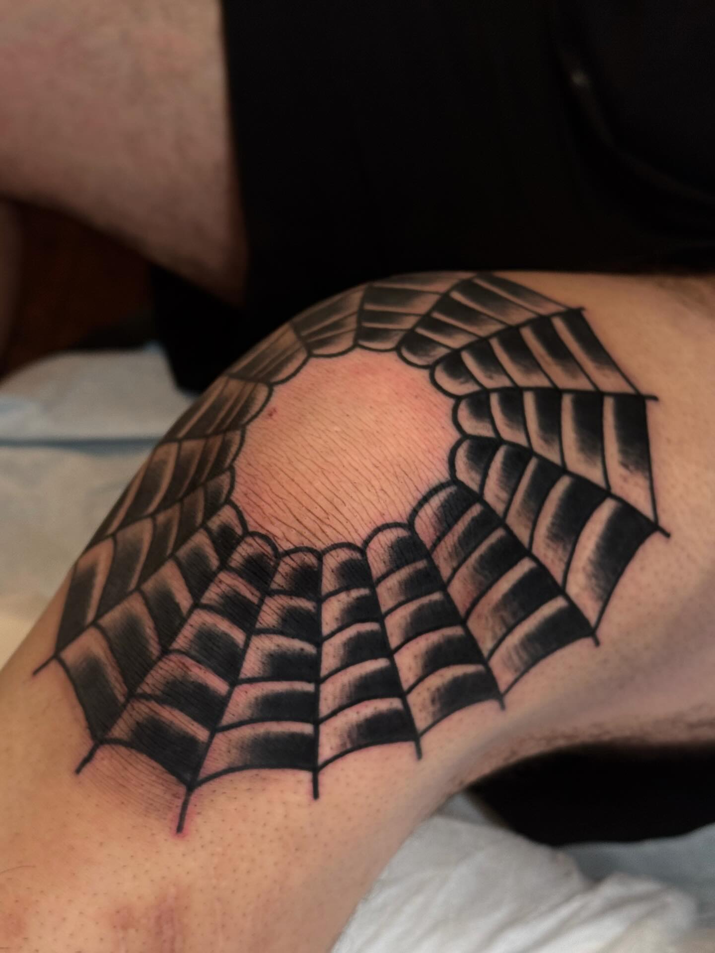 Spiderweb black and grey tattoo on the thigh by Bryce Shearer
