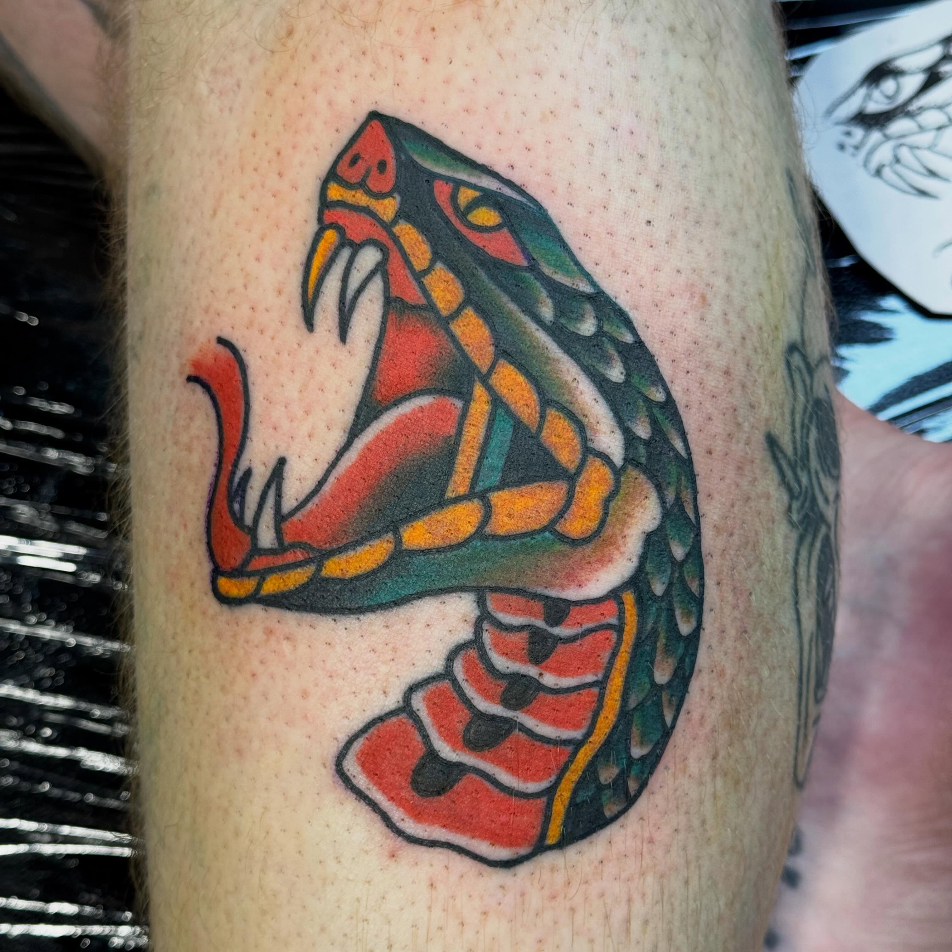 Snake American traditional tattoo on the forearm by Jack Hatchet Tattoos