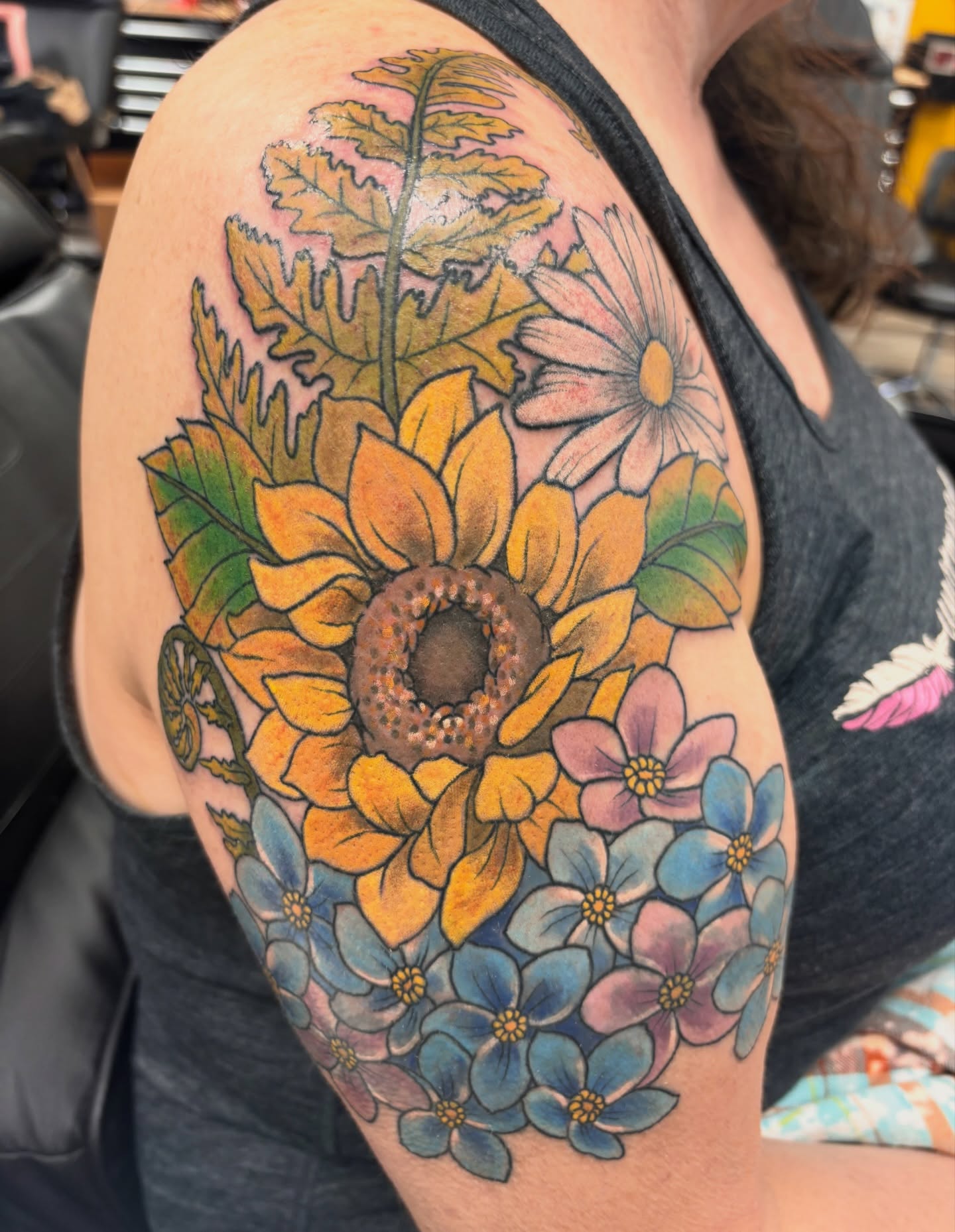 Sunflowers and daisies new school tattoo on the shoulder by Megan