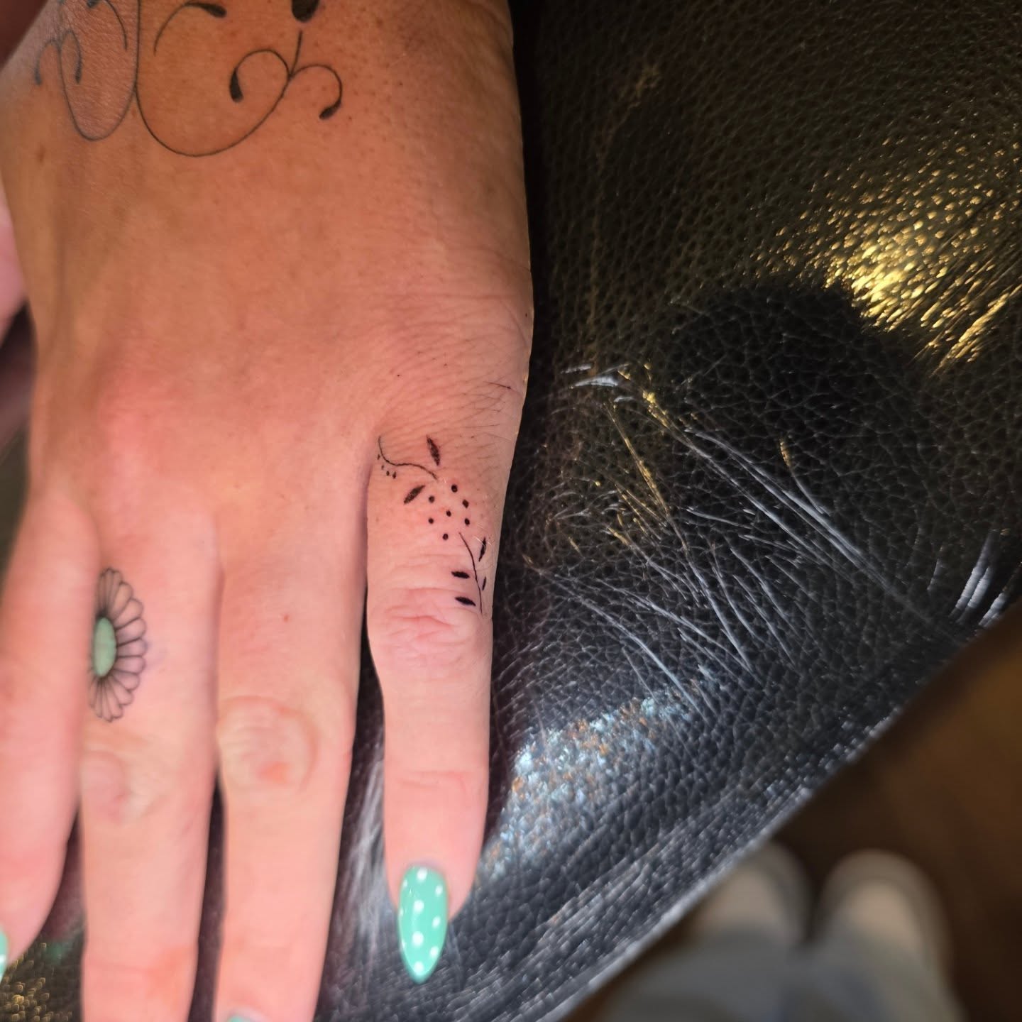 Flower and vine dotwork tattoo on the hand by Maggie