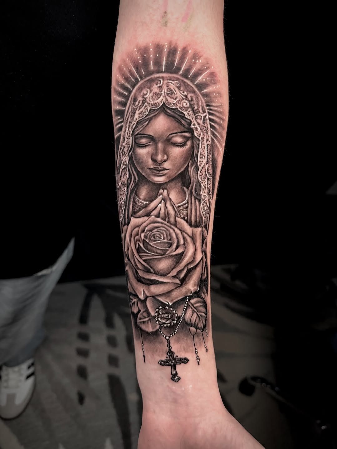 Virgin Mary with rose and cross Chicano tattoo on the forearm by John Ayson, Murrieta, California