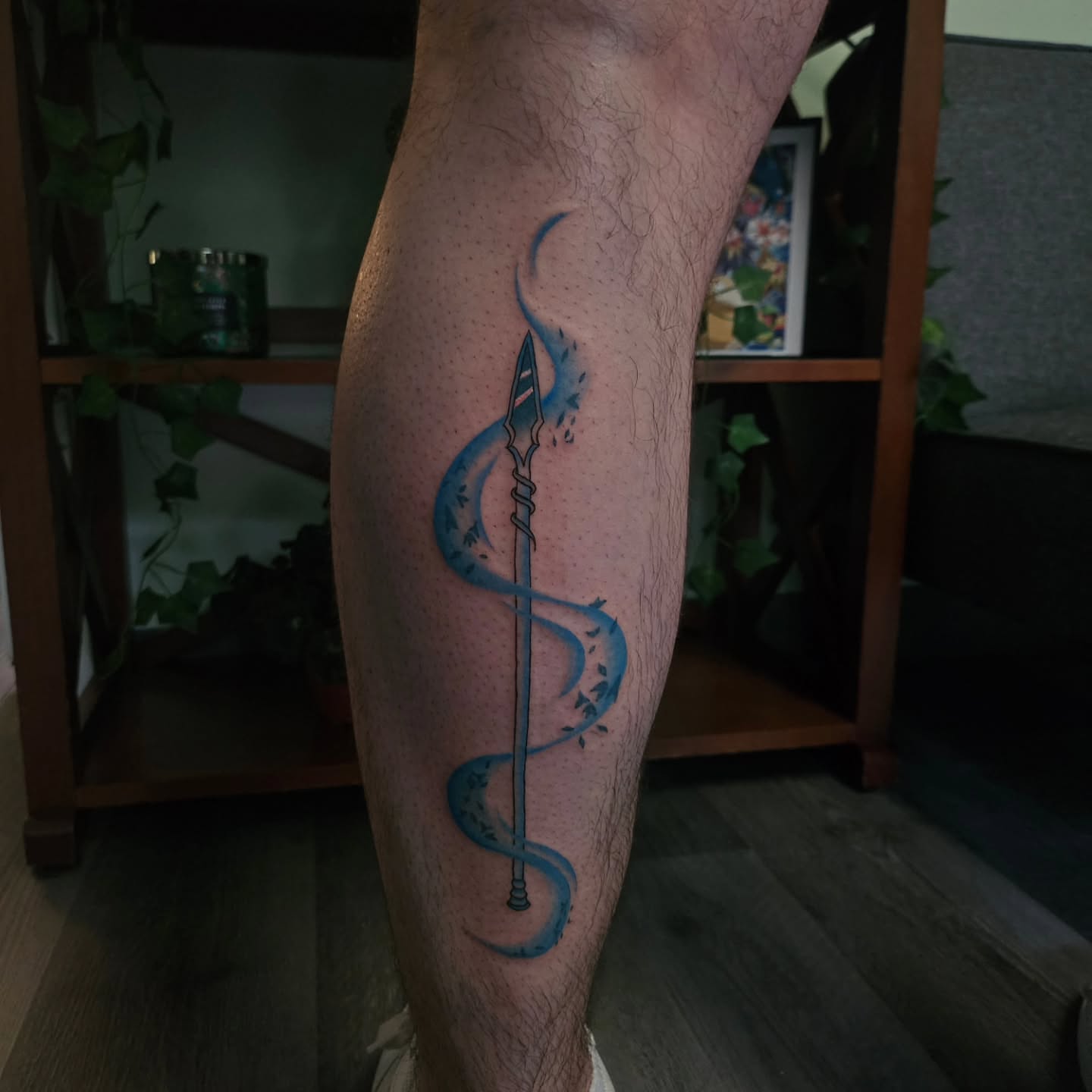 Spear with blue swirl dotwork tattoo on the calf by ݁˖