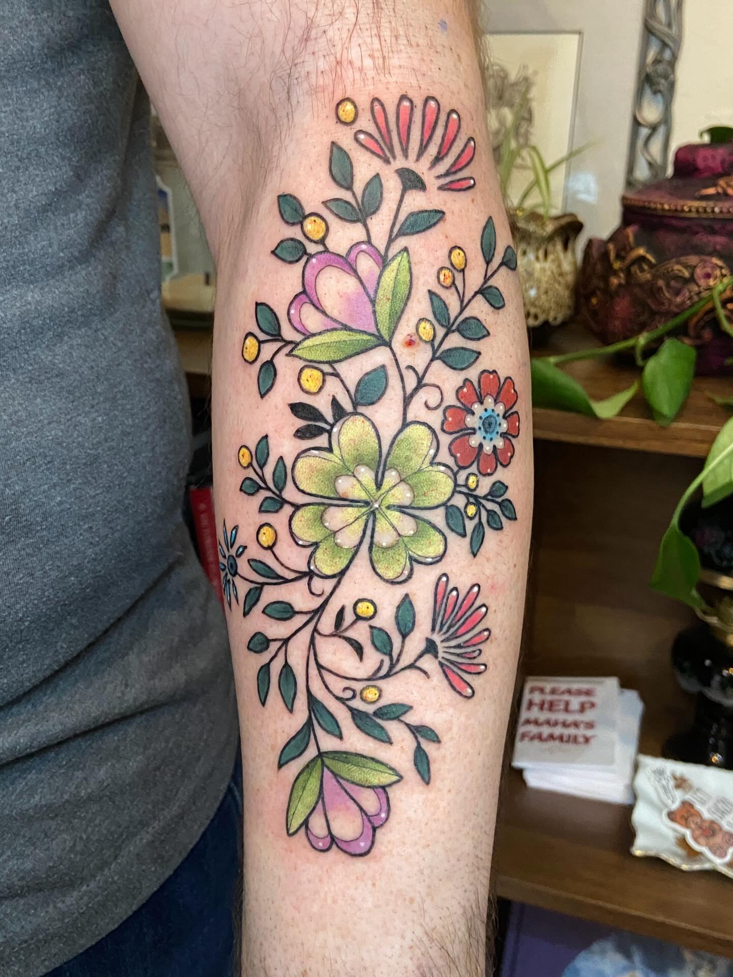 Floral arrangement watercolor tattoo on the forearm by Dawn Carr, Richmond, Virginia