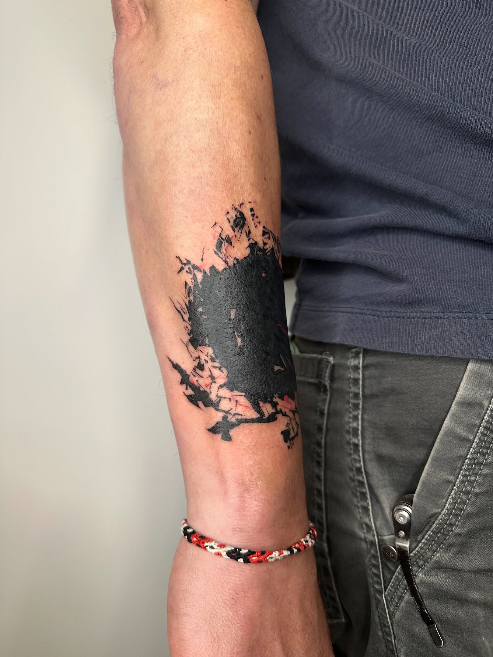 Abstract splatter dotwork tattoo on the forearm by reid - tattoo artist
