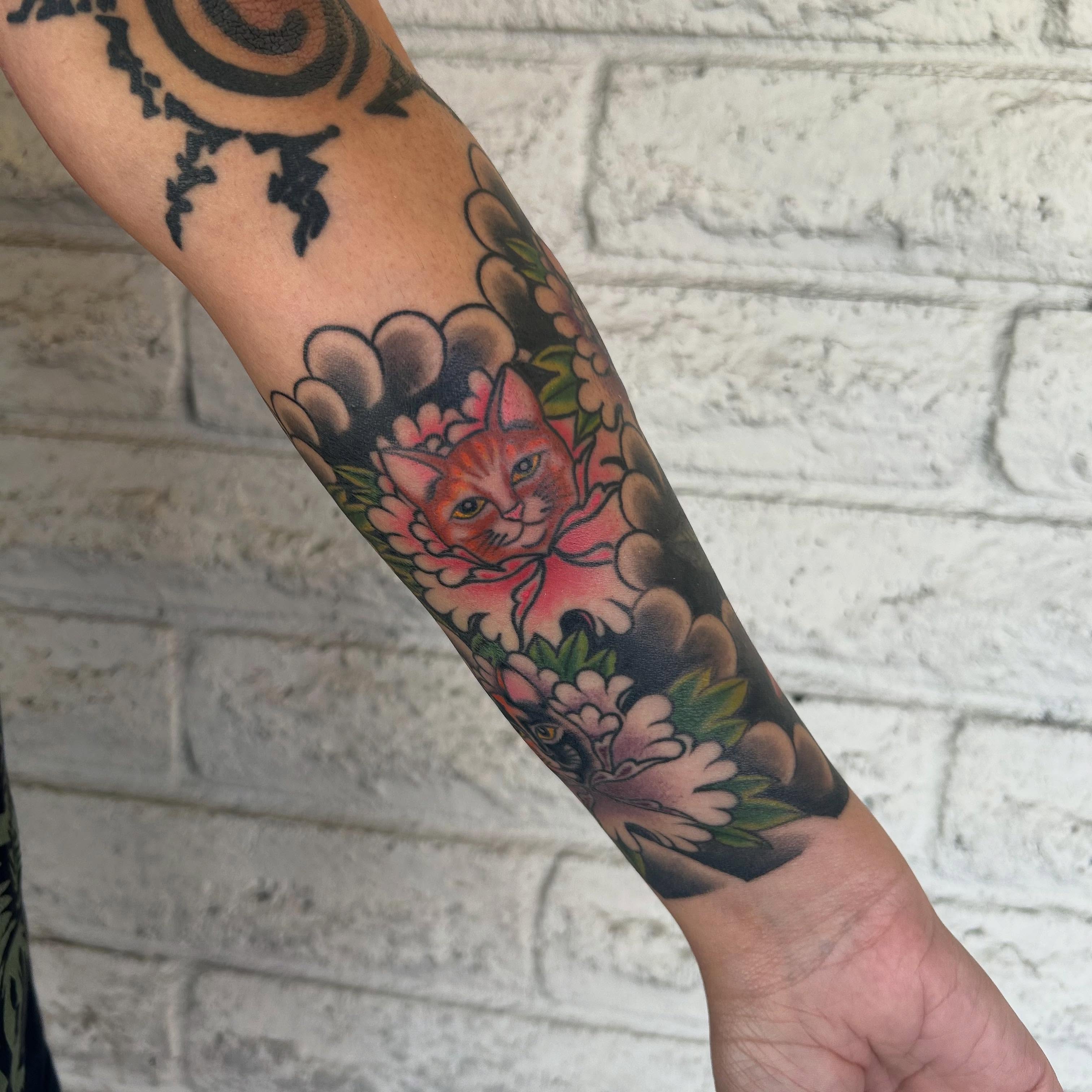 Cat and flowers American traditional tattoo on the forearm by Stephen Sanchez