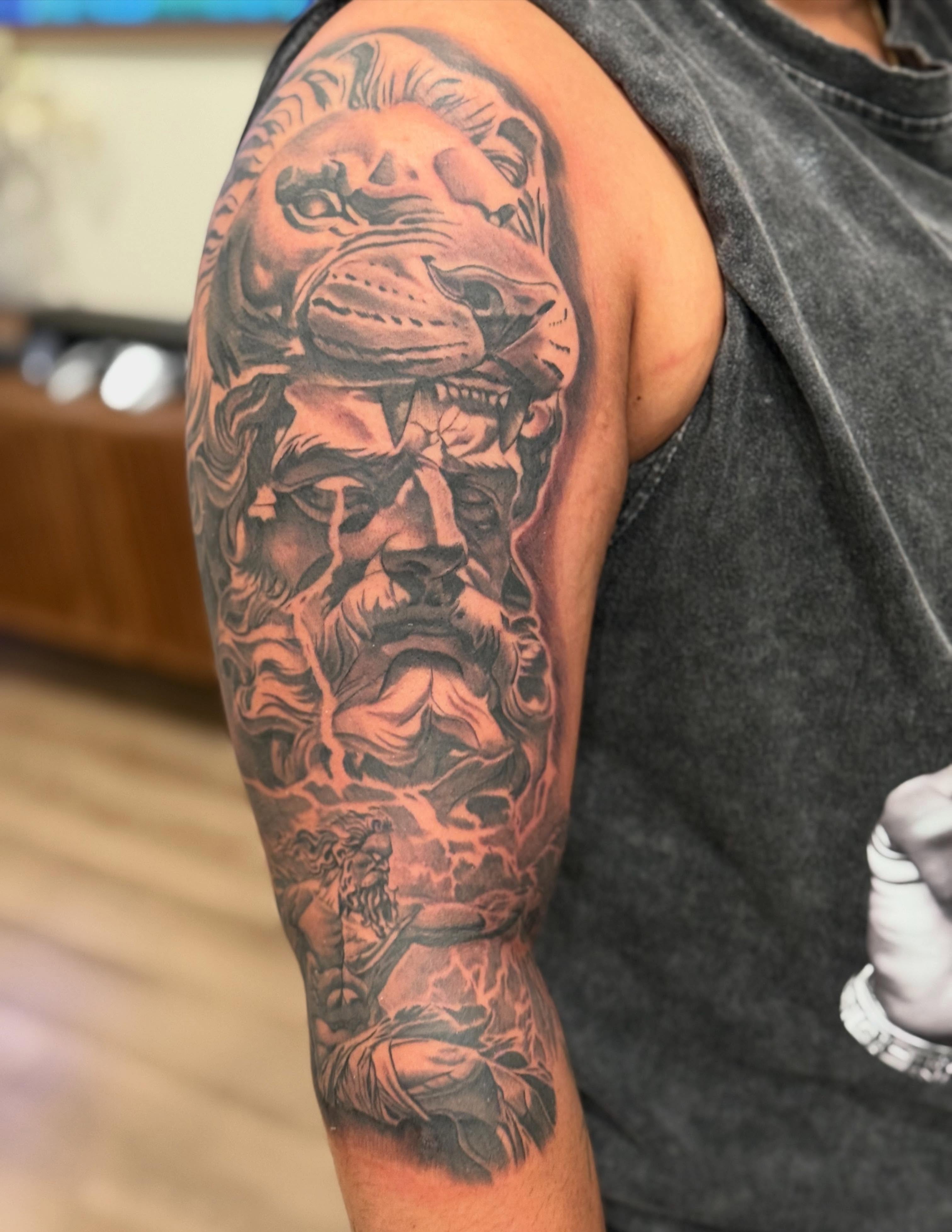 Bull and man realism tattoo on the upper arm by Joseph Pacheco