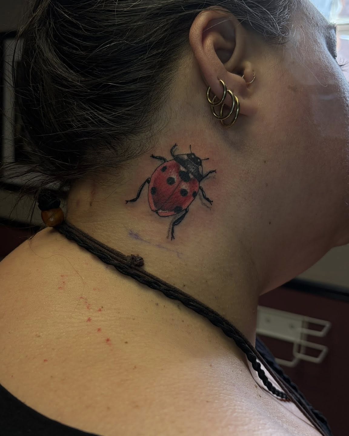 Ladybug realism tattoo on the neck by Joel Ortiz Ginorio