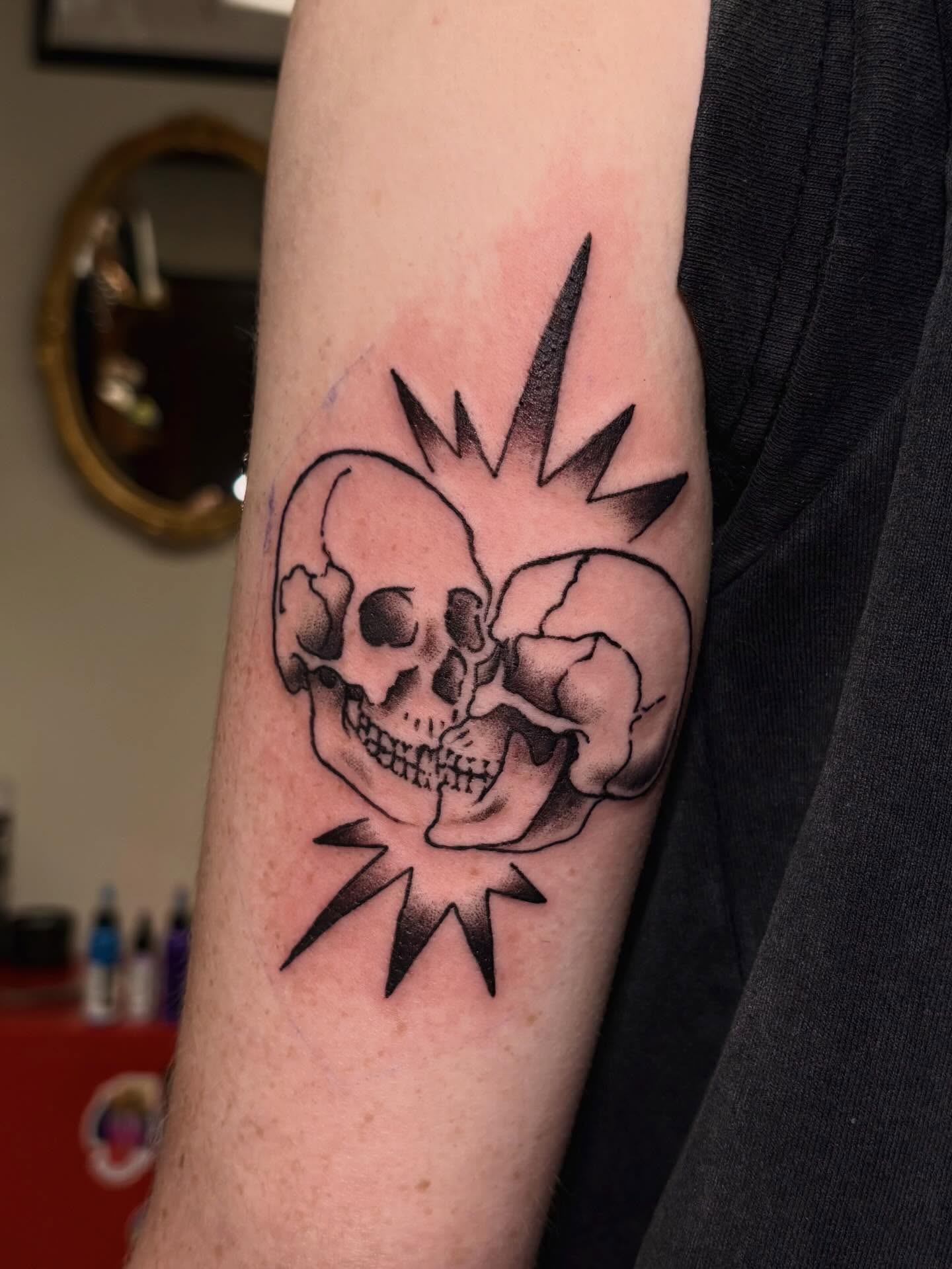Skulls black and grey tattoo on the forearm by kane