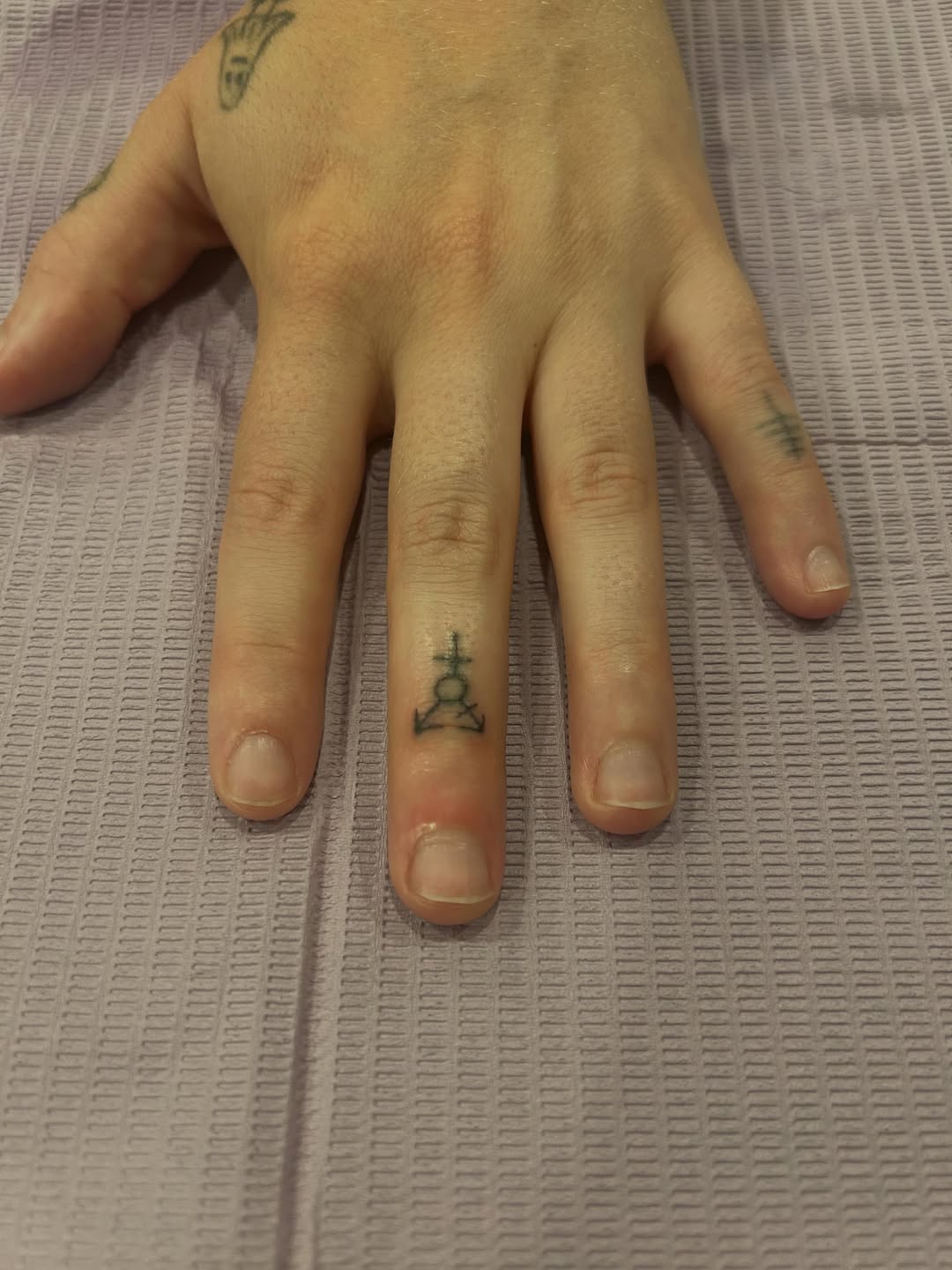 Symbol tattoo on the hand by Emma D
