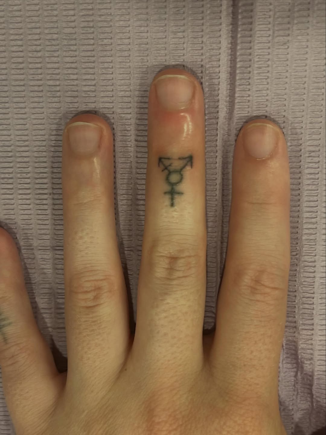 Transgender symbol tattoo on the hand by Emma D