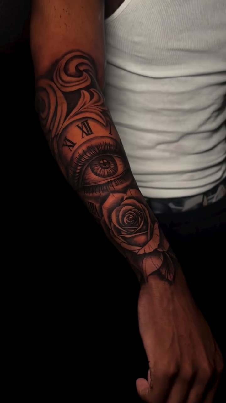 Clock, roses, and swirling patterns realism tattoo by Thomas