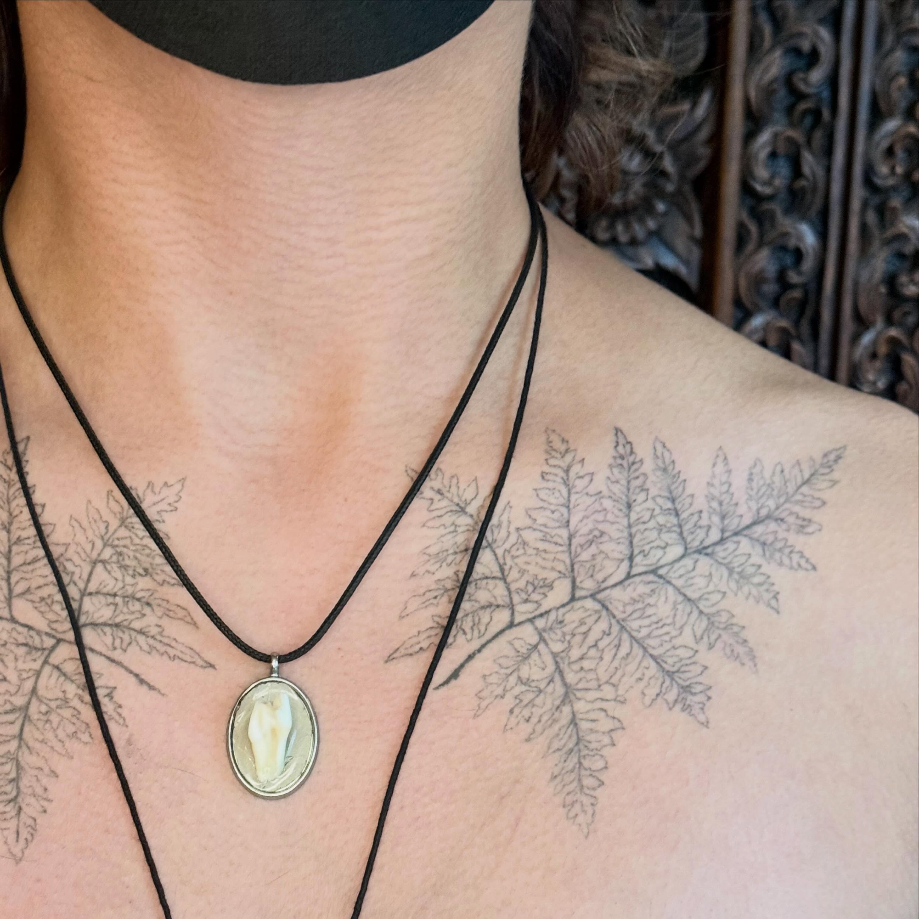 Fern leaf black and grey tattoo on the chest by Emily Rose Lumsdaine