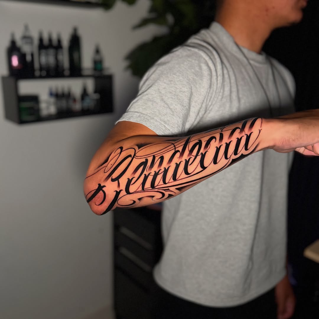 Script lettering lettering tattoo on the forearm by InkbyCasillas