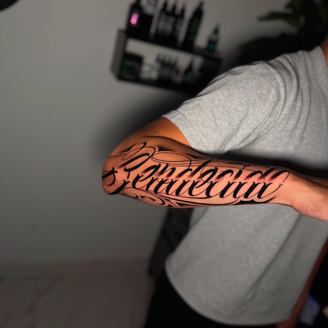 Script lettering lettering tattoo on the forearm by InkbyCasillas
