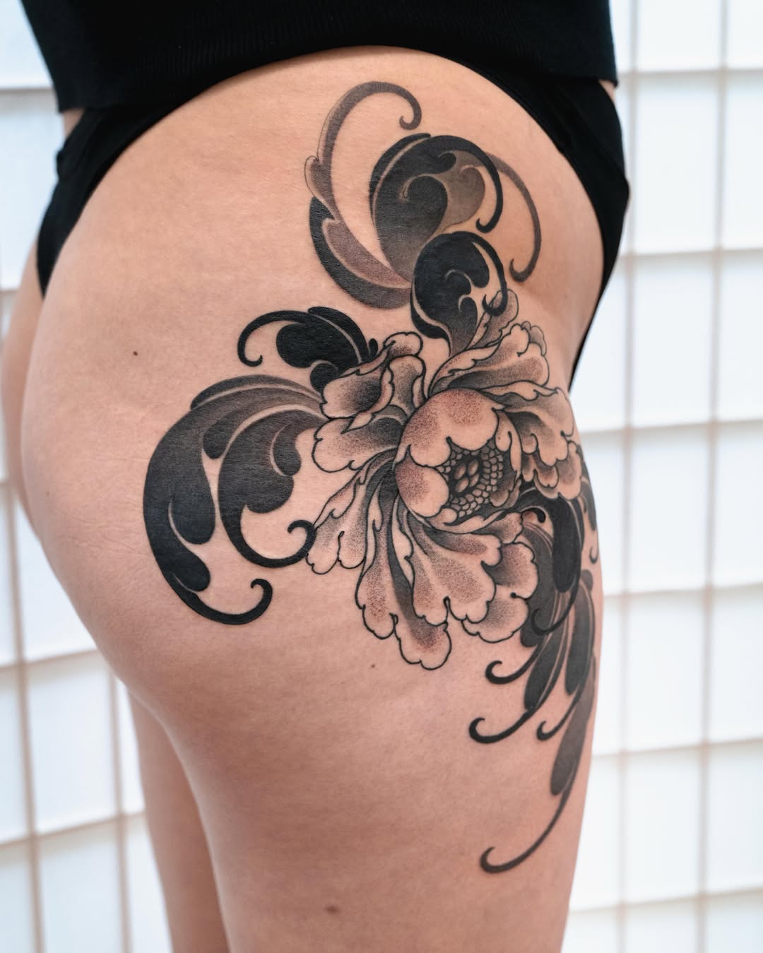 Peony with swirling patterns tribal tattoo on the thigh by Matt Leibo, San Francisco, California